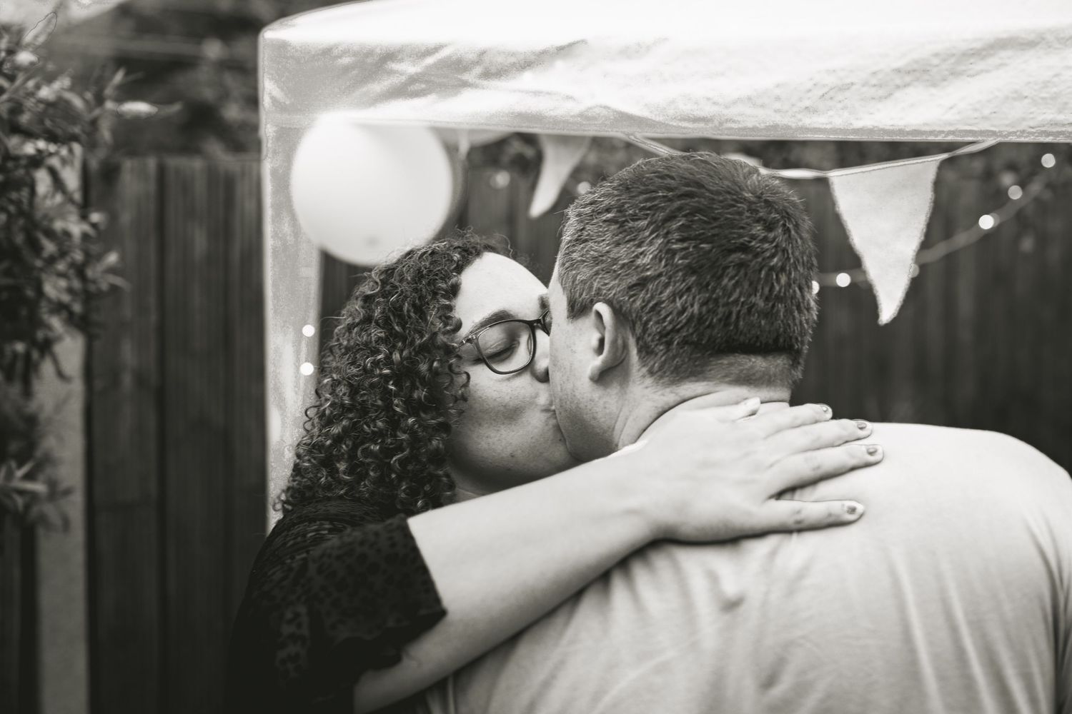 Engagement party, bride and groom to be kissing
