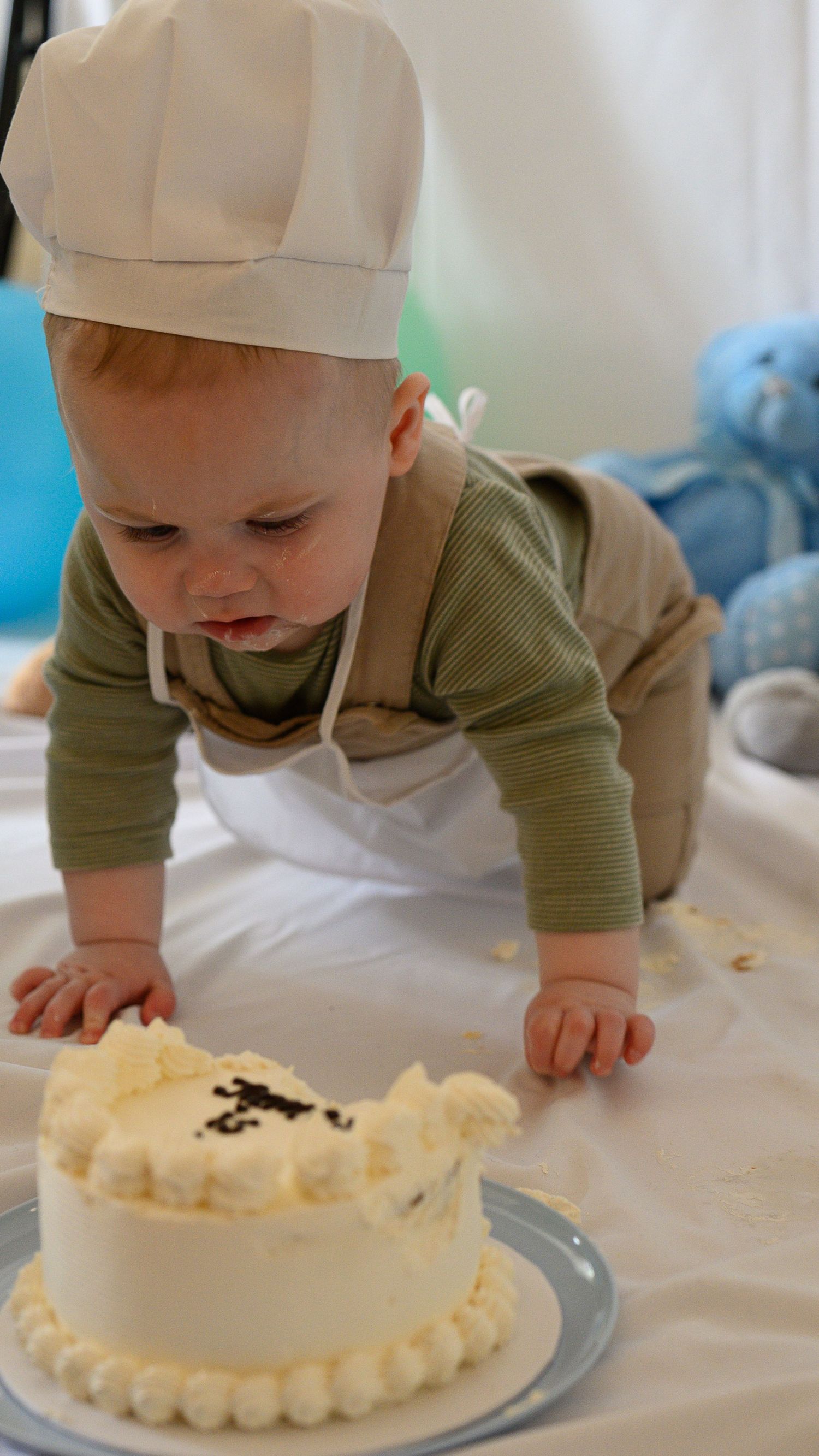 Toddler crawling towards cake