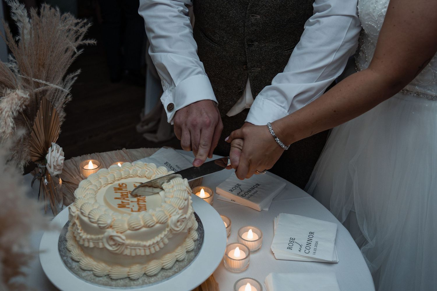 Essex bride and groom cutting cake