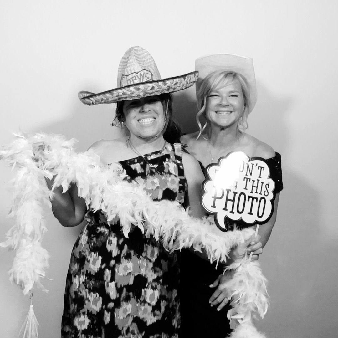 Guests with fun props posing in the Twist Photo Booths photo booth at a Phoenix, AZ wedding