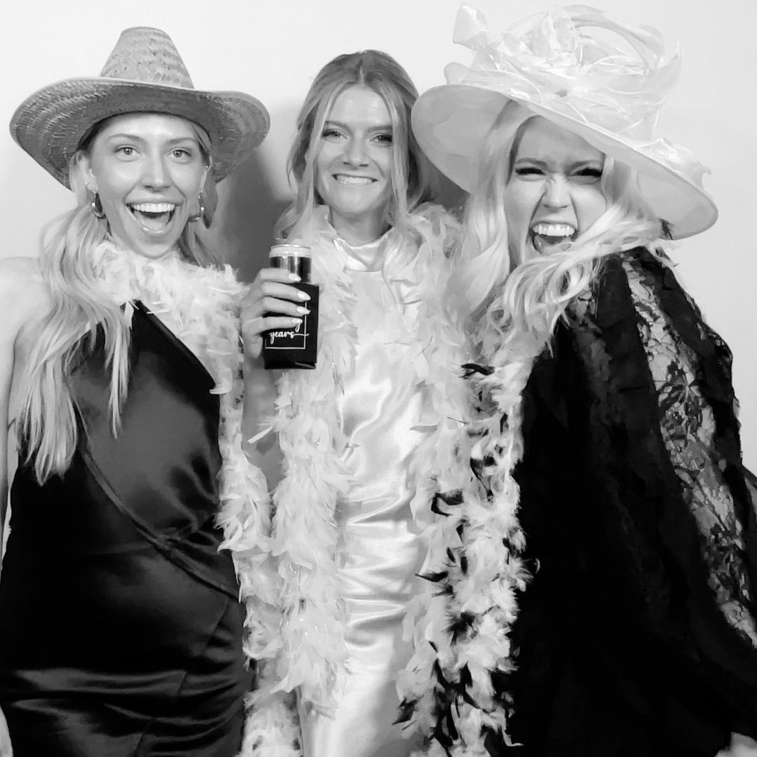 Guests with fun props posing in the Twist Photo Booths photo booth at a Phoenix, AZ wedding