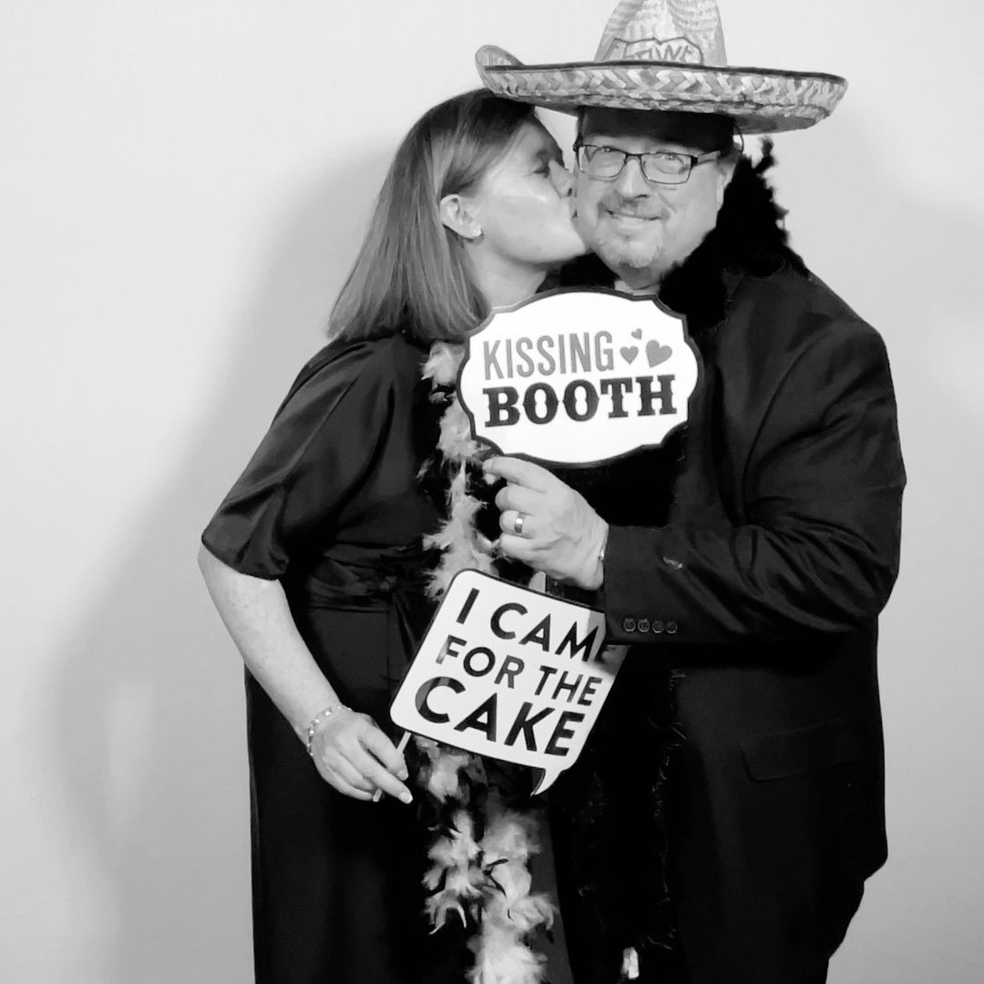 Guests with fun props posing in the Twist Photo Booths photo booth at a Phoenix, AZ wedding