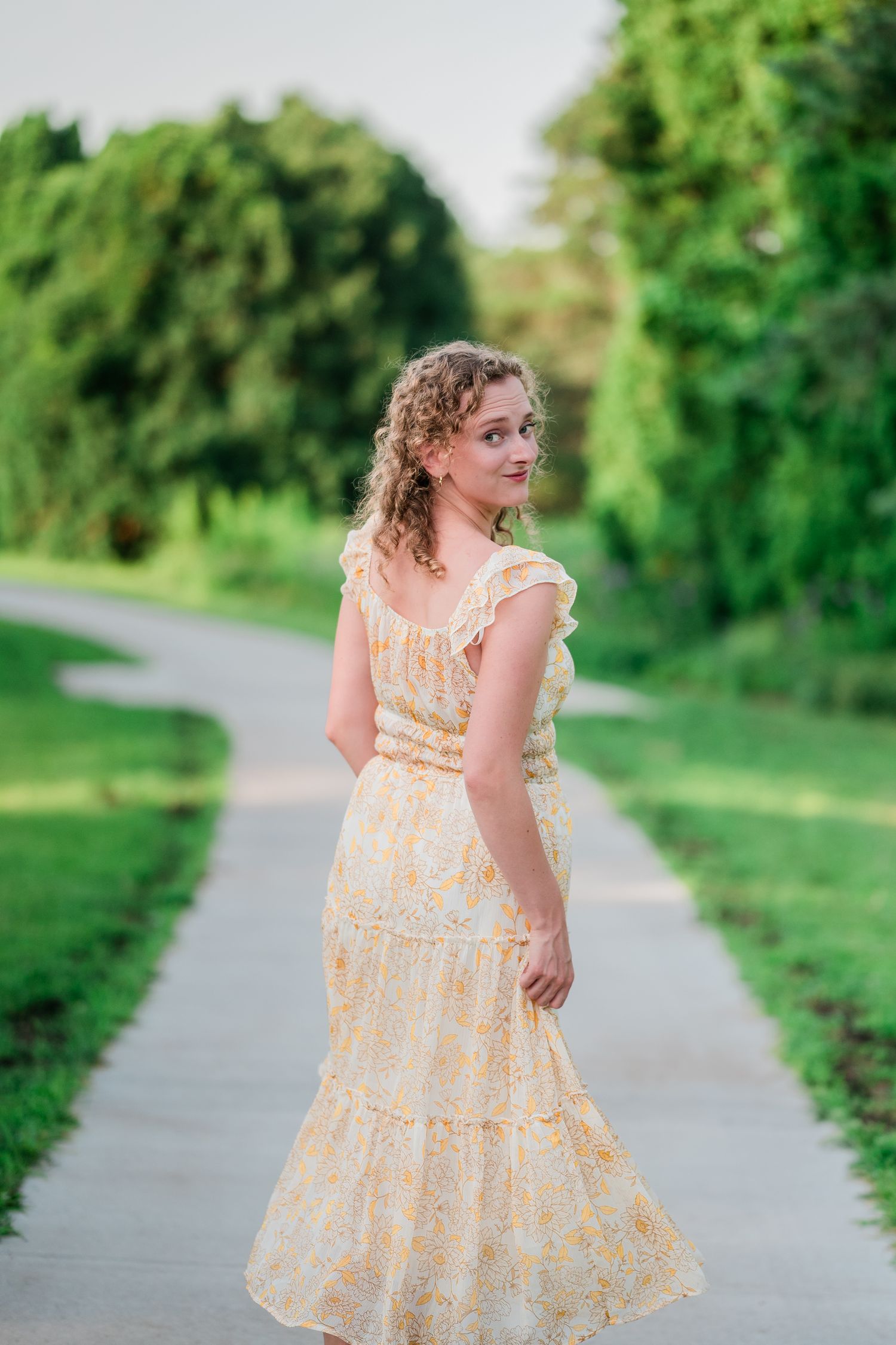 Portrait of Emmy from Emmy Faye Photography, a Minnesota Wedding & Portrait Photographer around lush greenery at Arneson Acres Park at dawn