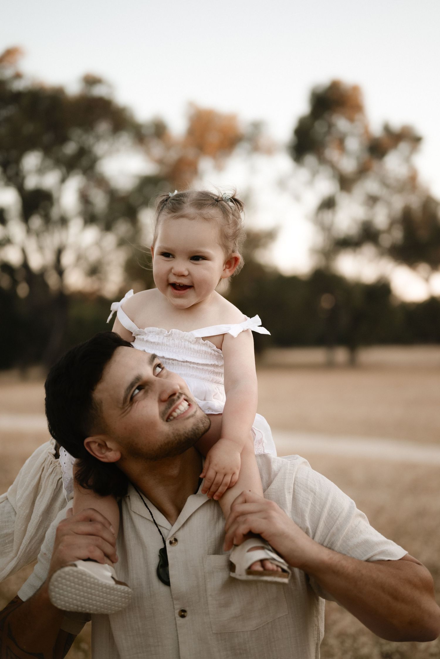 Joyful moment shared between adult and child during outdoor portrait session.