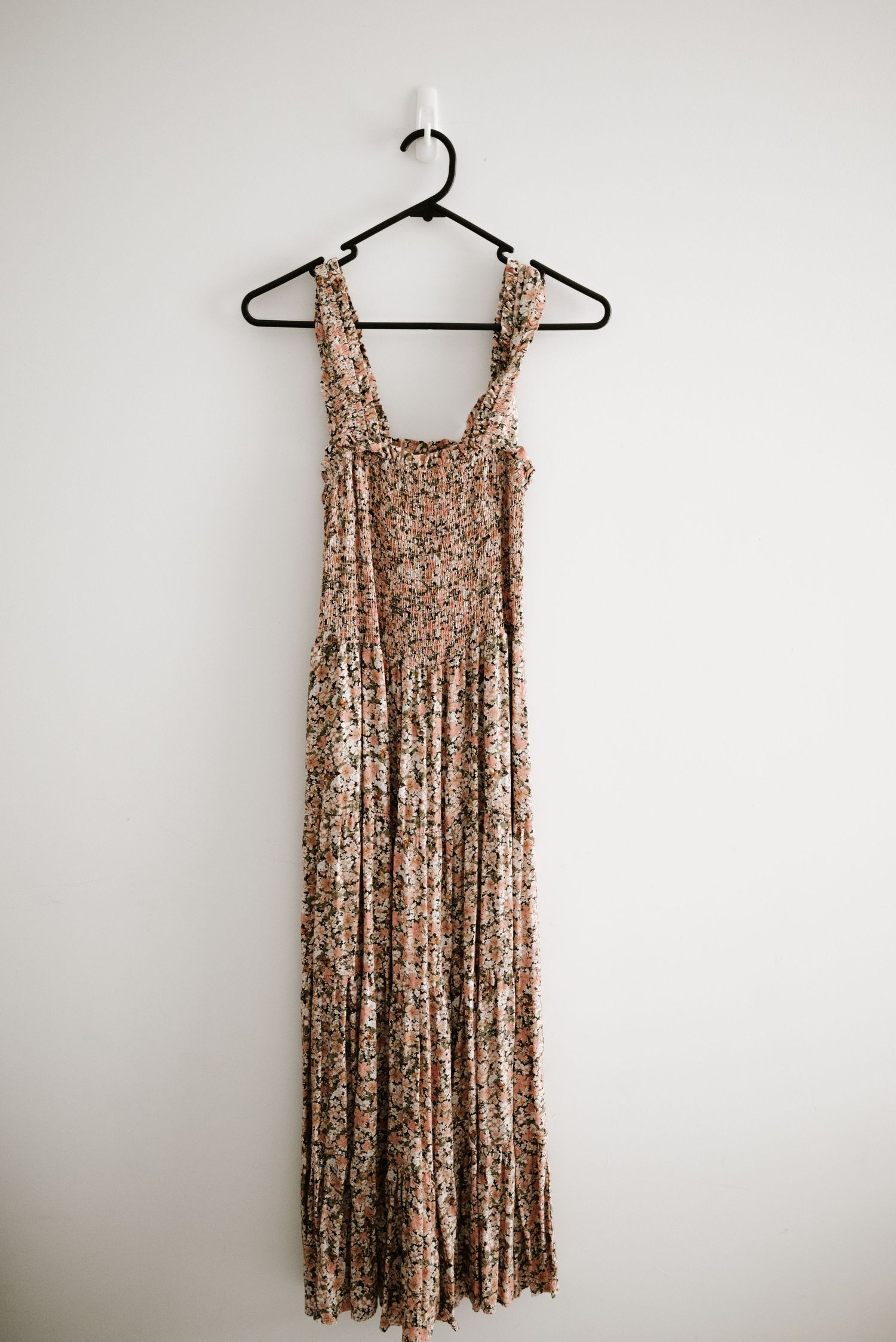 Sequined champagne-colored maxi dress with tank straps hanging on black hanger.