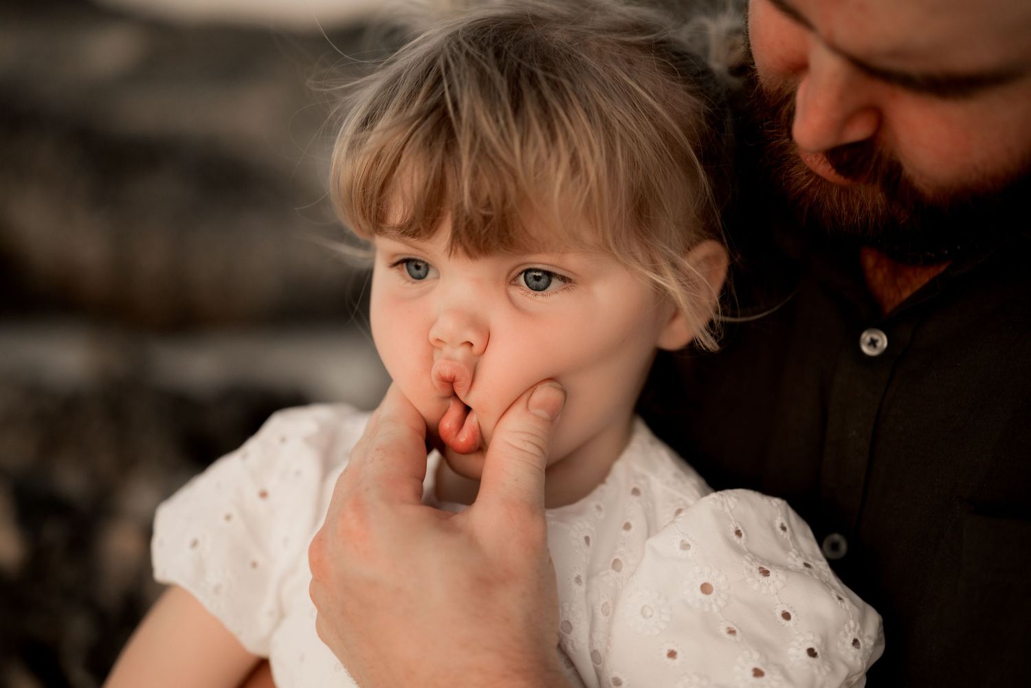 Close-up candid moment captured during outdoor family photoshoot.