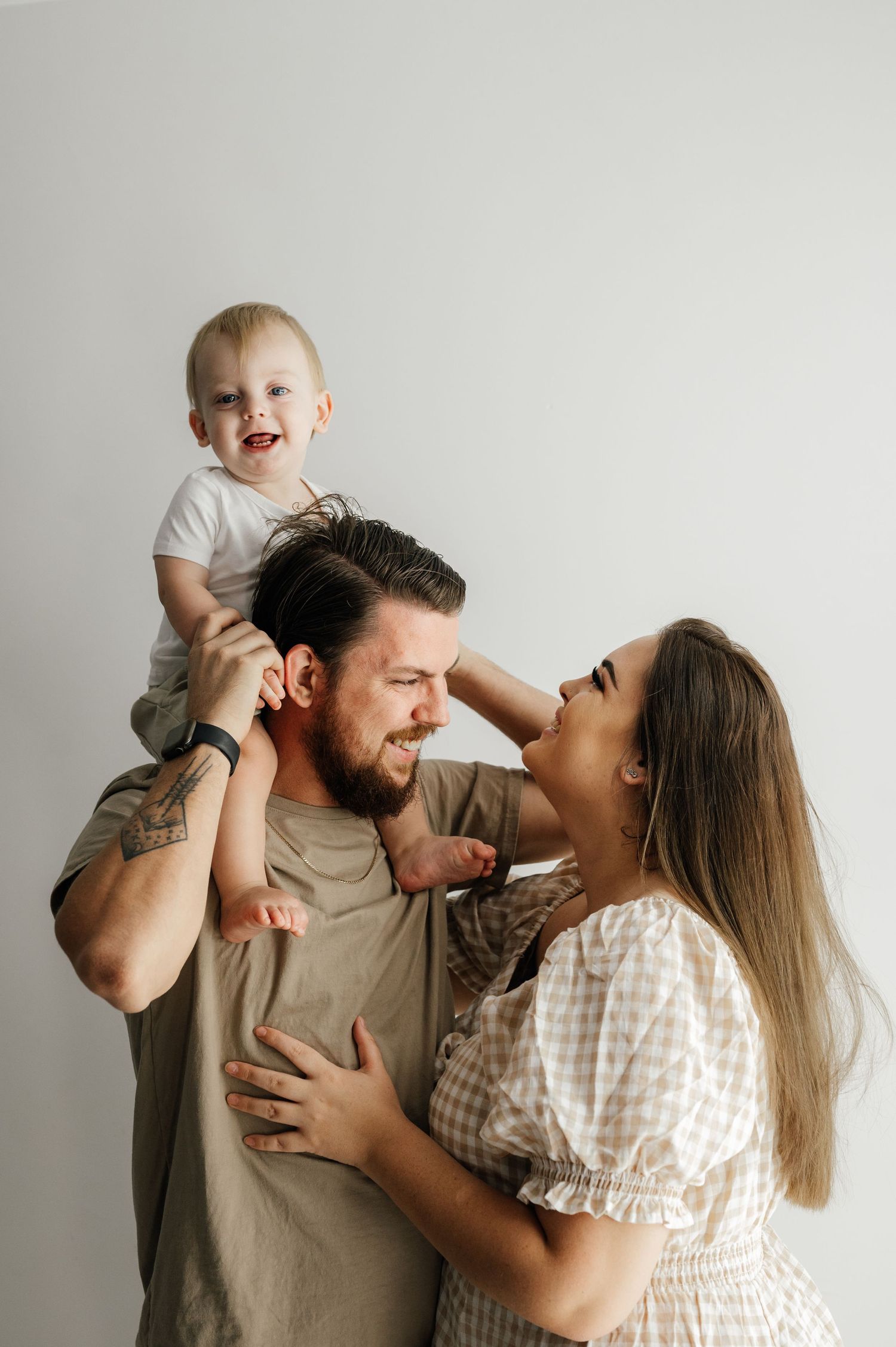 A joyful family moment captured against a white background.