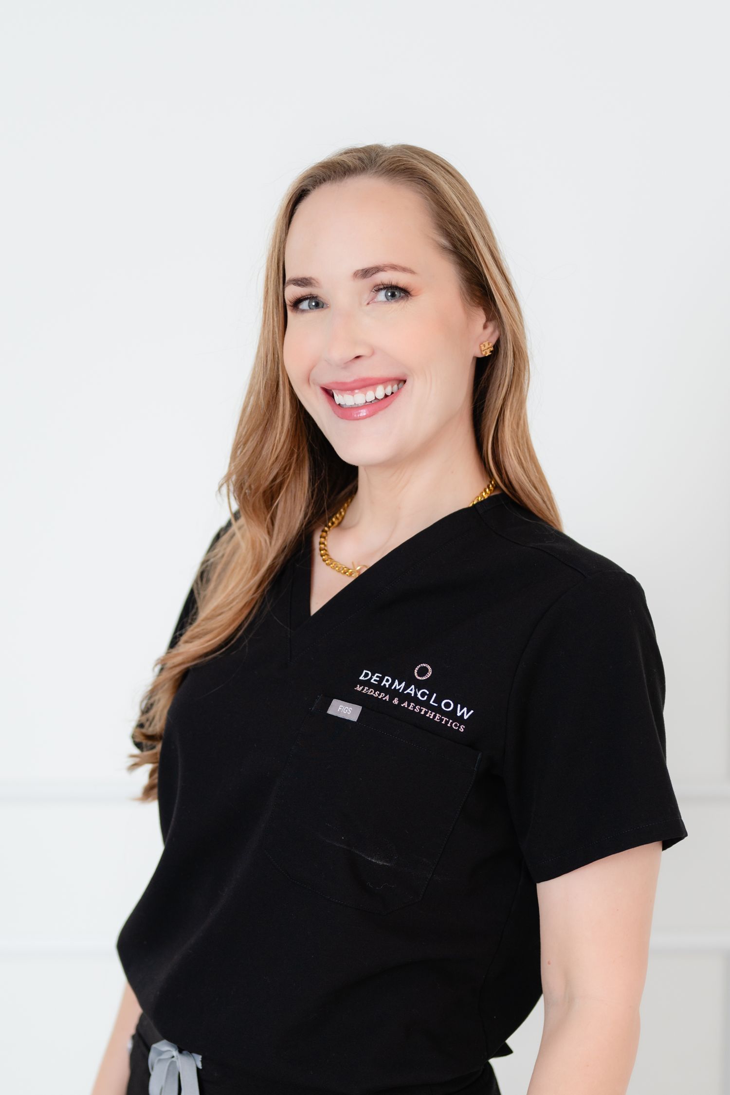 Healthcare professional wearing black uniform posing against white background.