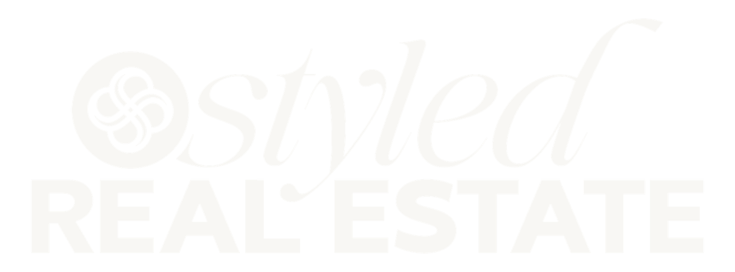 A faded white real estate logo or watermark appears on a light background.