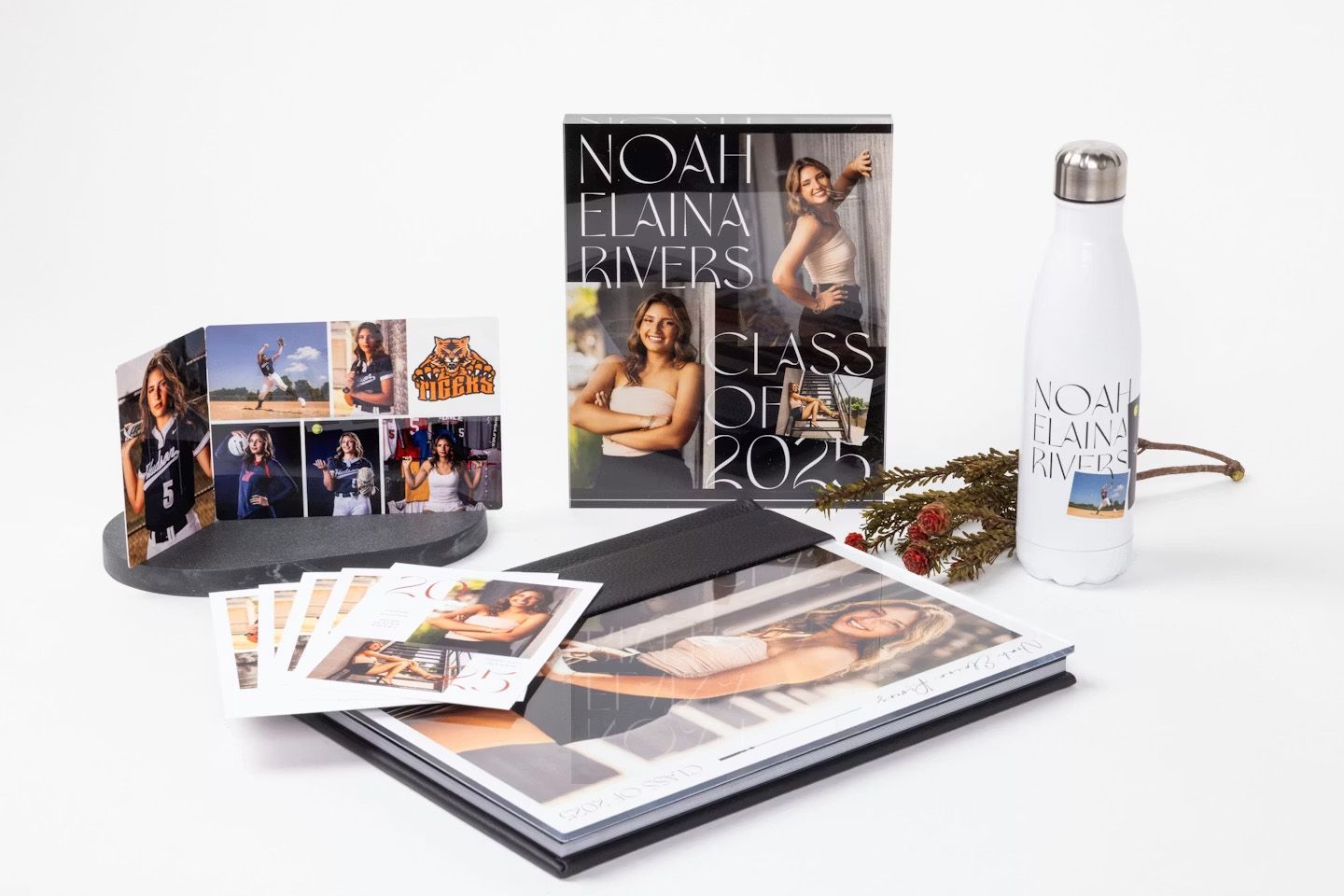 A series of fashion magazine layouts and portfolio books displayed in a clean white studio setting.