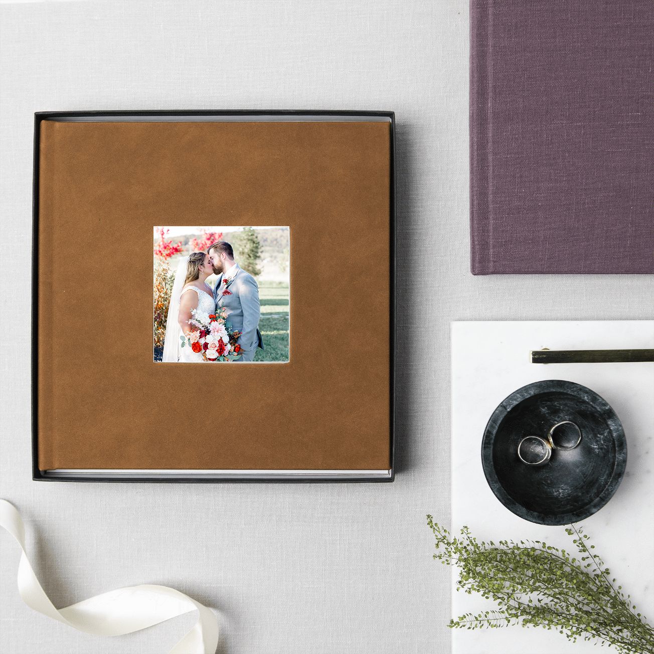 Minimalist photo layout showing brown and purple album covers arranged in a clean, modern grid pattern against white background.