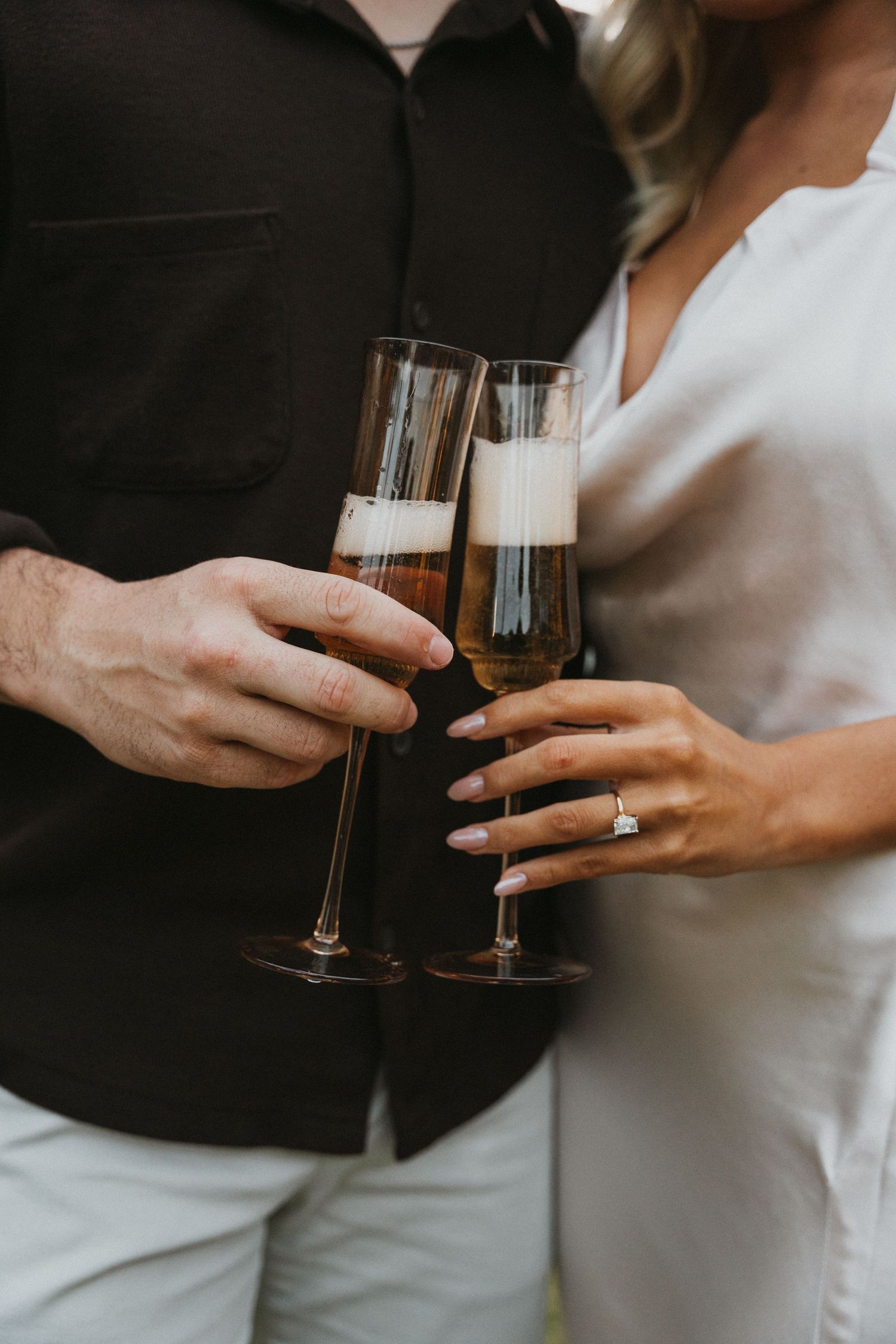 Close-up of champagne glasses clinking during a celebration moment.