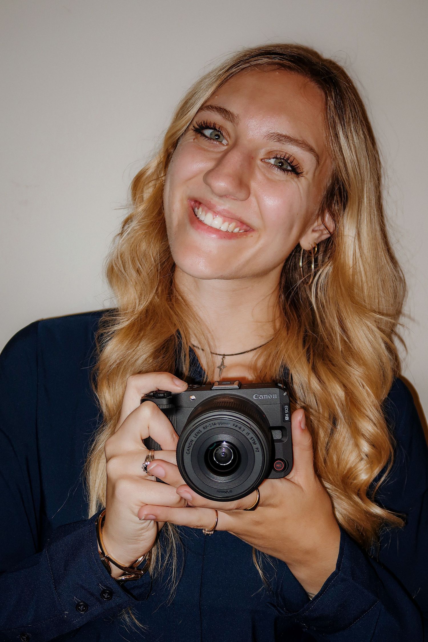 Girl smiling with a camera for a headshot