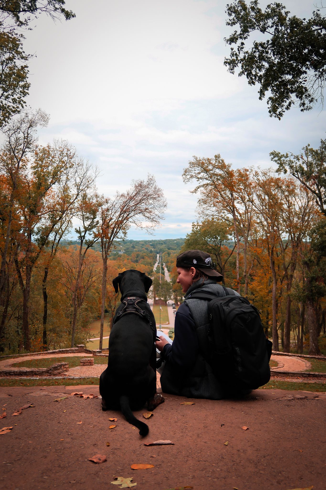 Girl and her dog looking out at the horizon for photoshoot