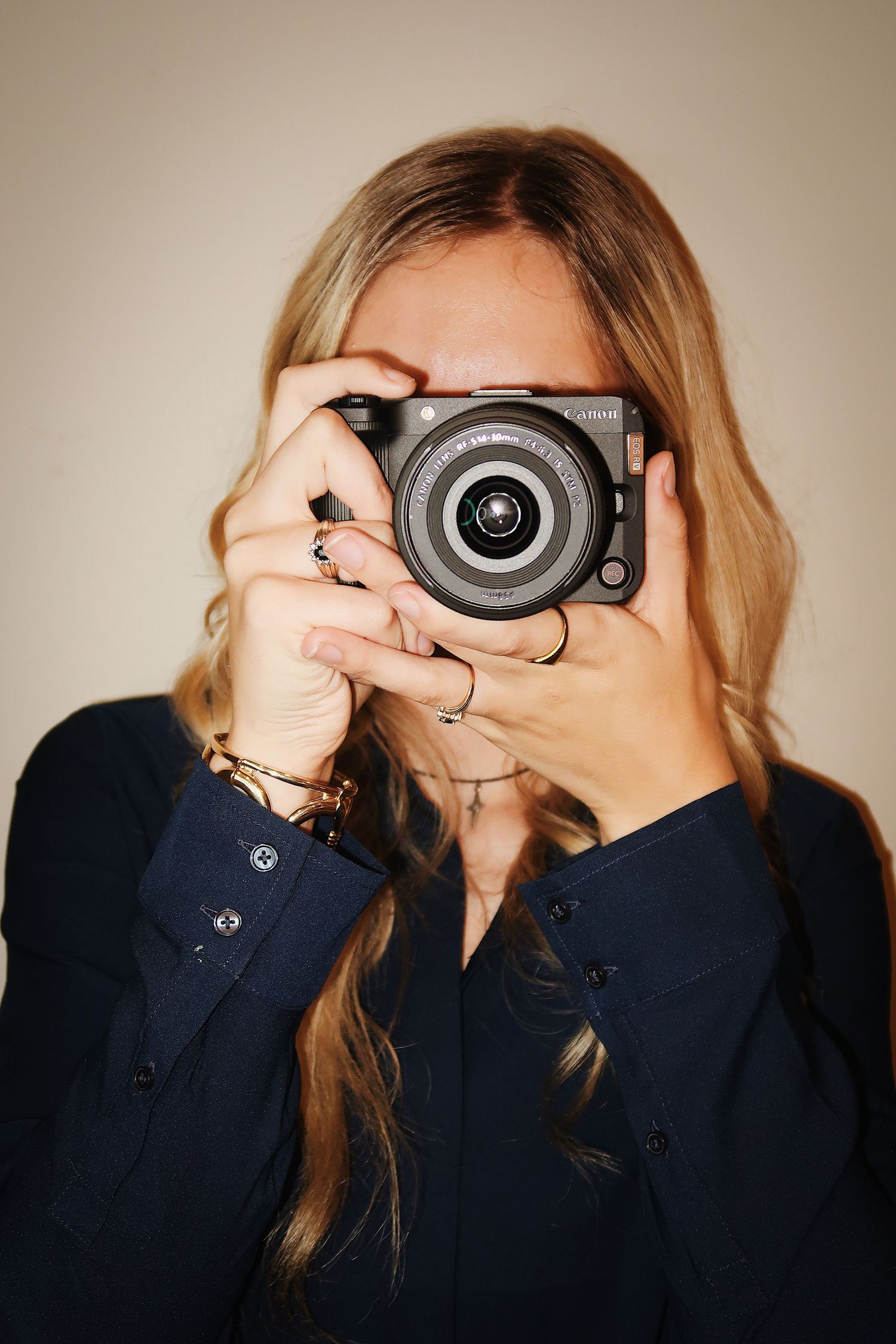 Girl smiling with a camera for a headshot