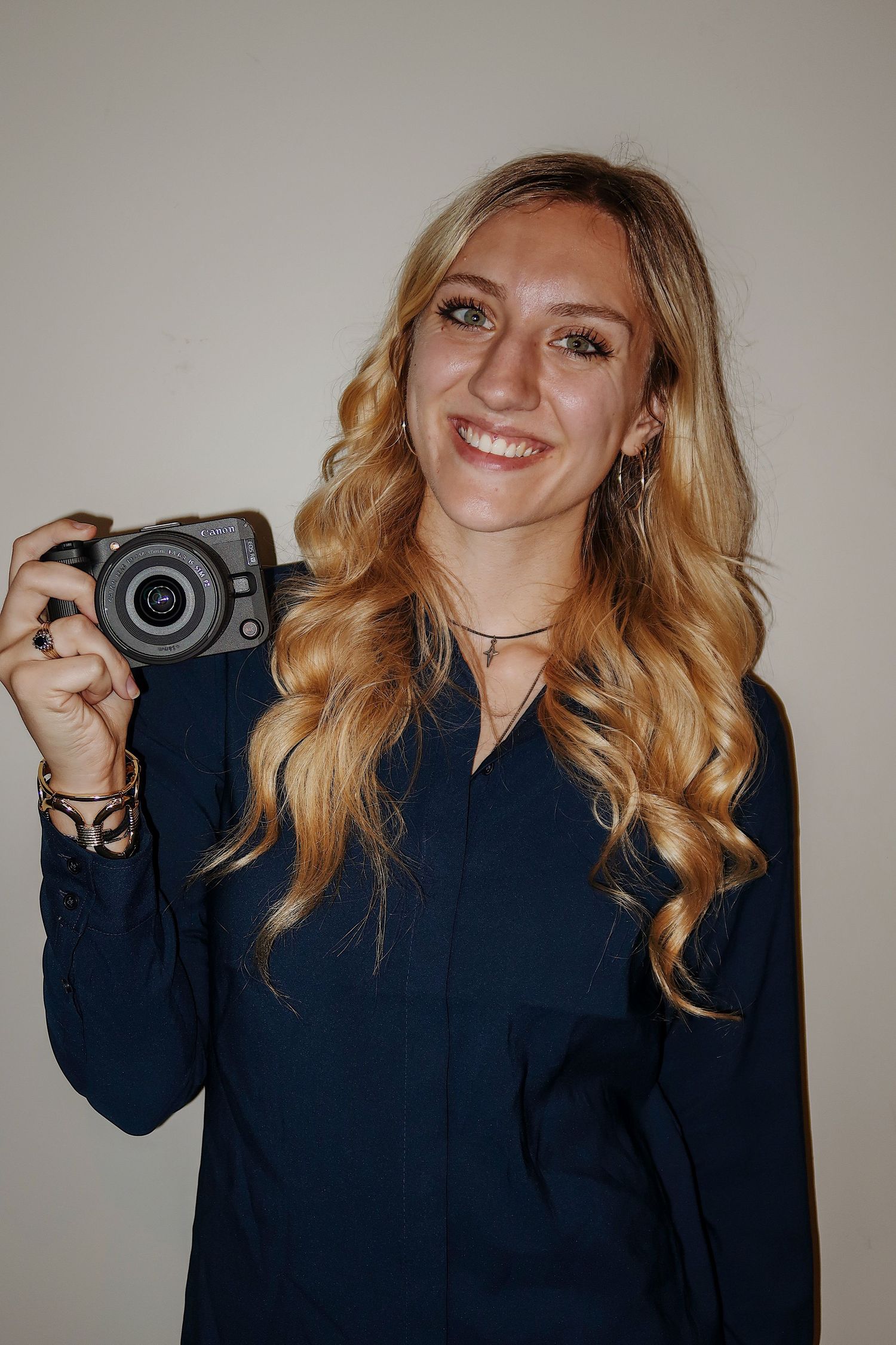Girl smiling with a camera for a headshot