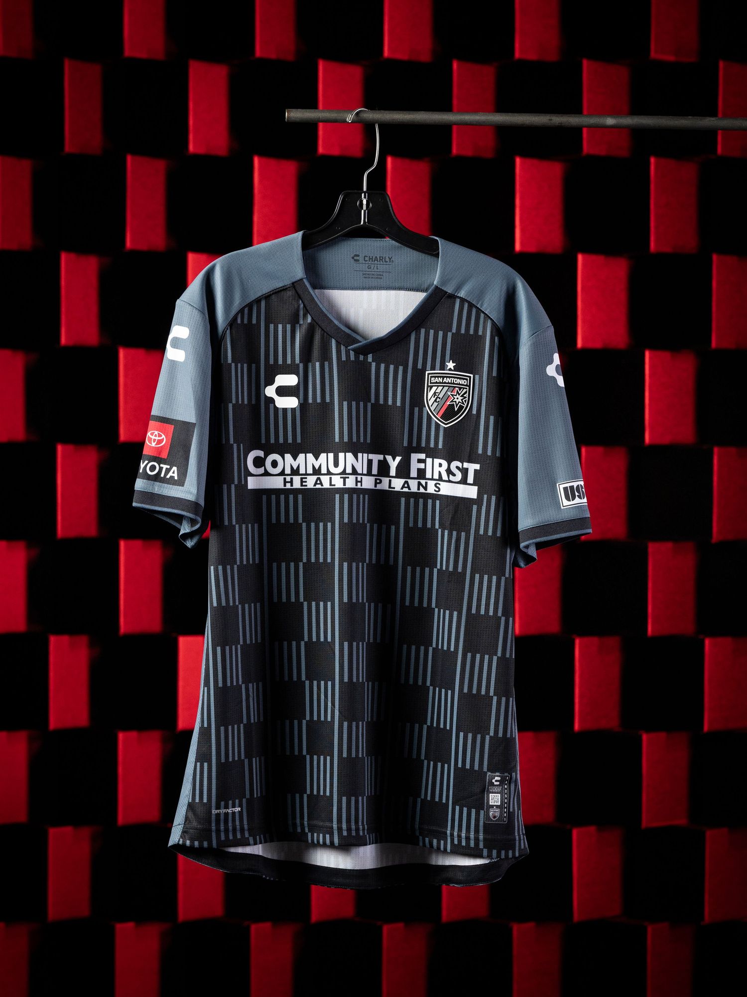 CHARLY soccer kit unveil photo - detailed shots of the USL (United Soccer League) number and logo, San Antonio professional soccer player
