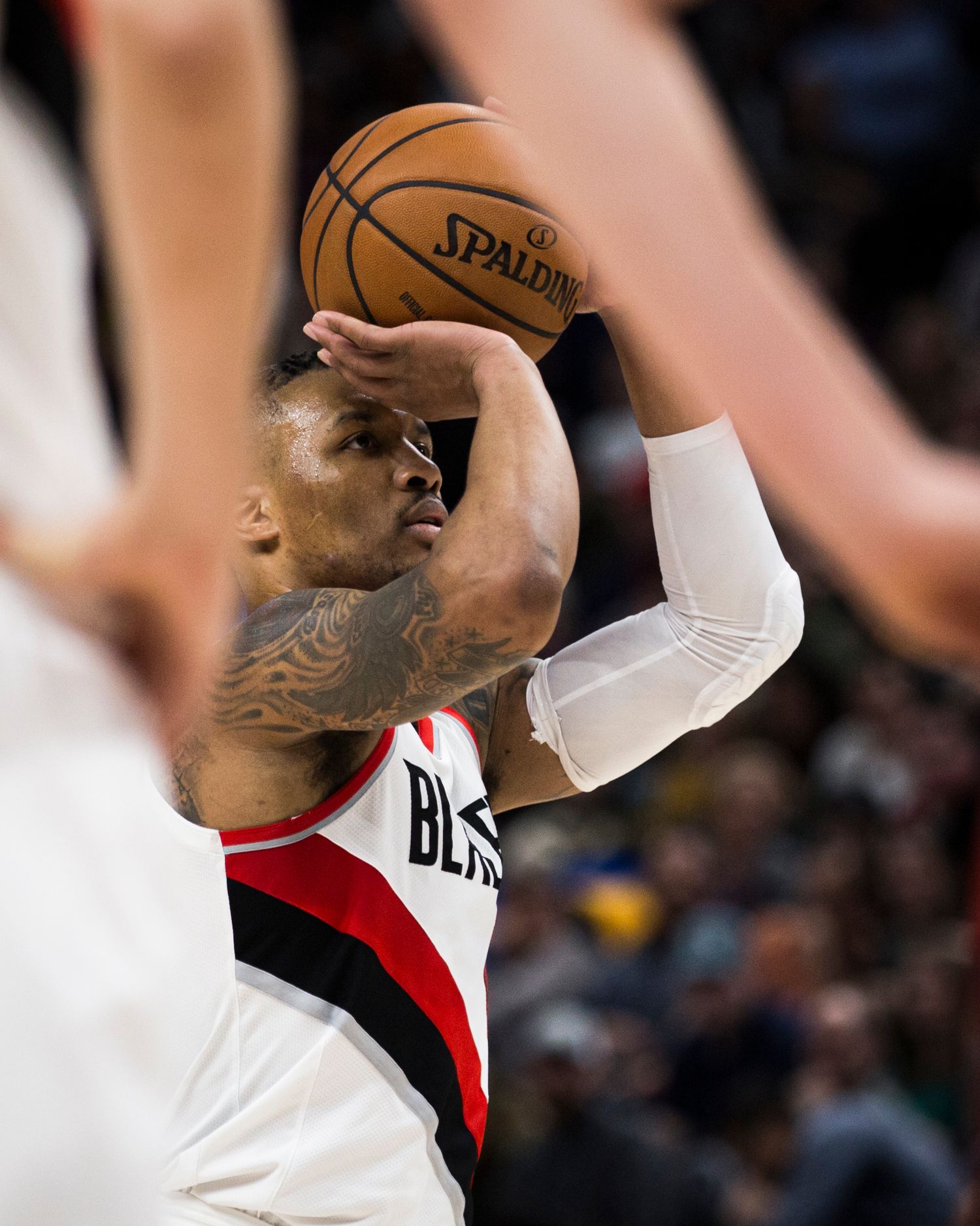 Basketball player in white jersey prepares to shoot during professional game.