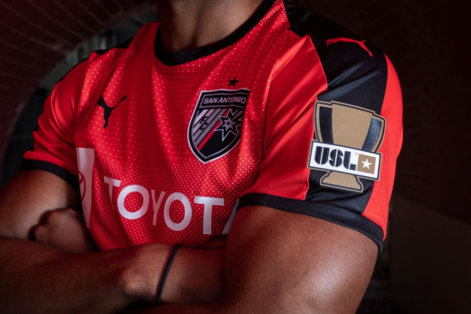 Close-up of red soccer jersey with Toyota sponsor and USL patch.
