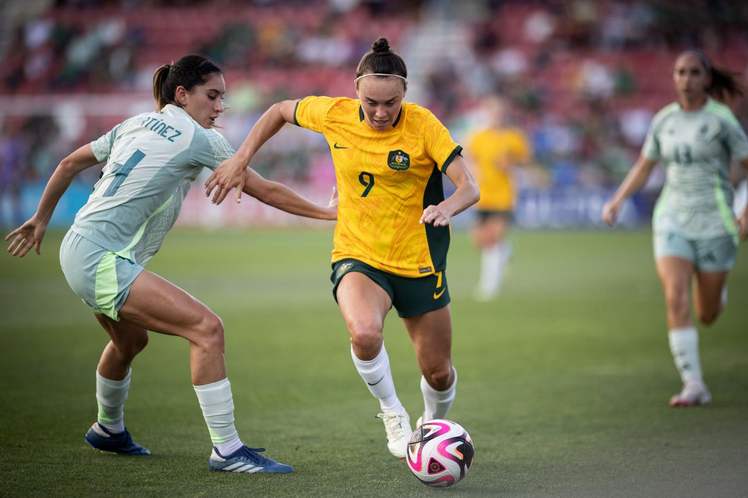 Soccer players compete for ball during Mexico vs Australia match.