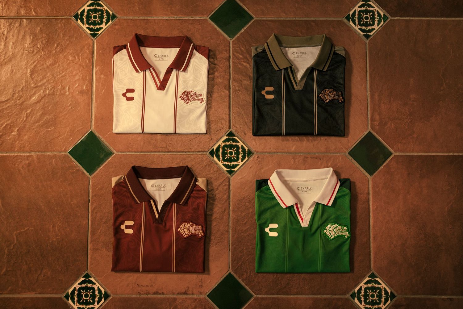A collection of vintage baseball jerseys displayed on a rustic wall with green diamond accents.