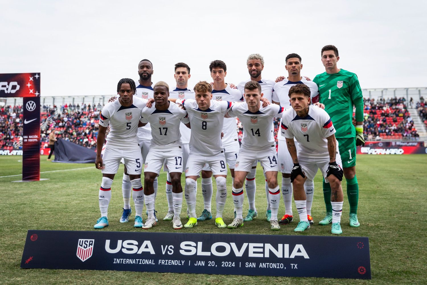 National soccer team poses for official pre-match photo on field.