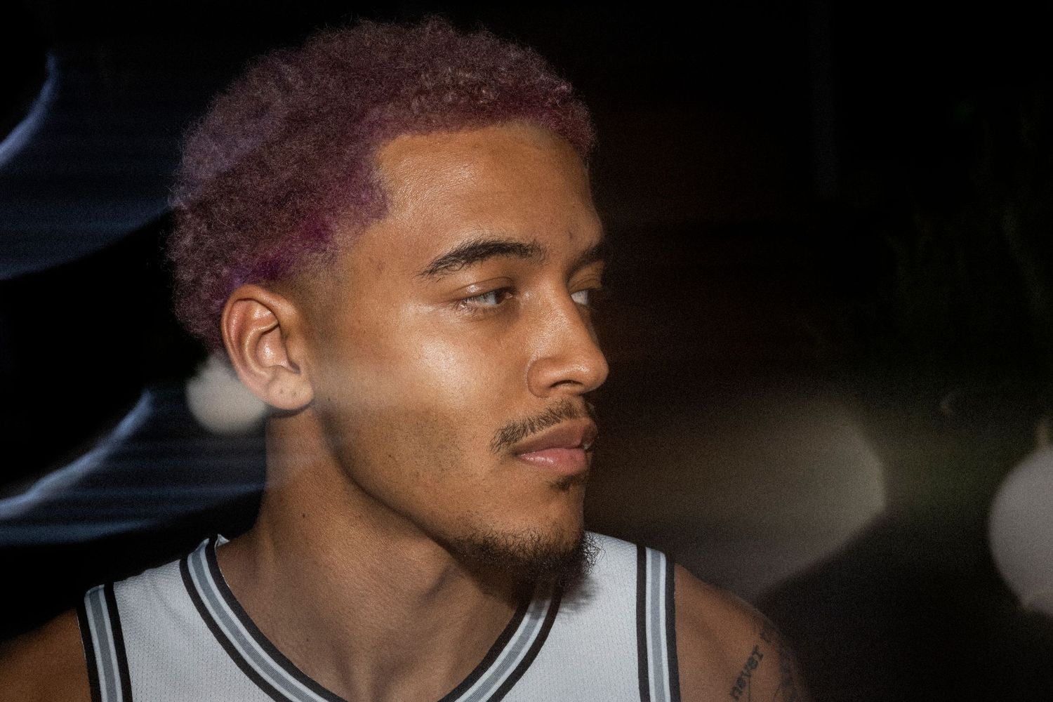 Portrait of athlete in moody lighting with bokeh effects.