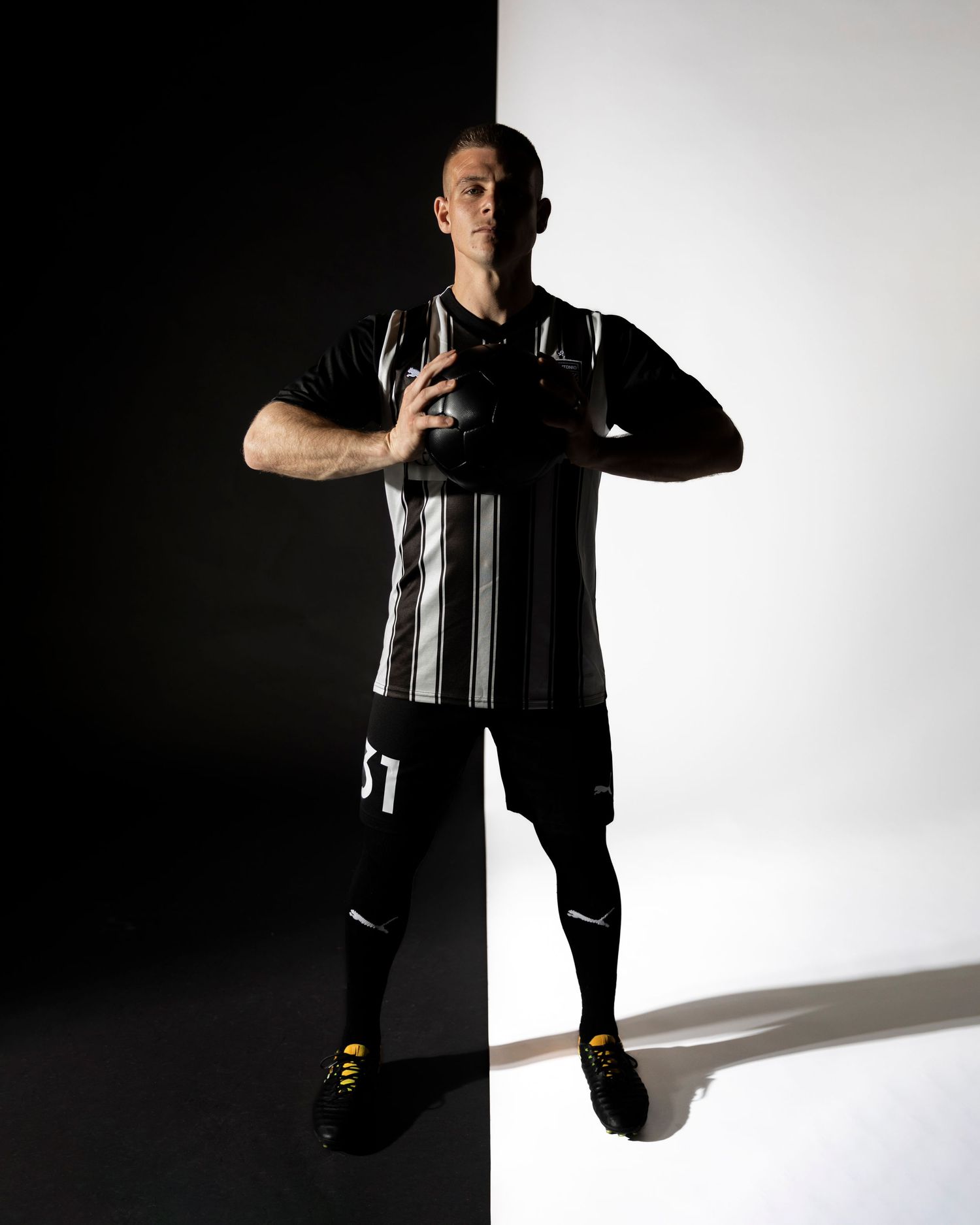 Silhouetted athlete performs dynamic movements against a white background in a photo sequence.