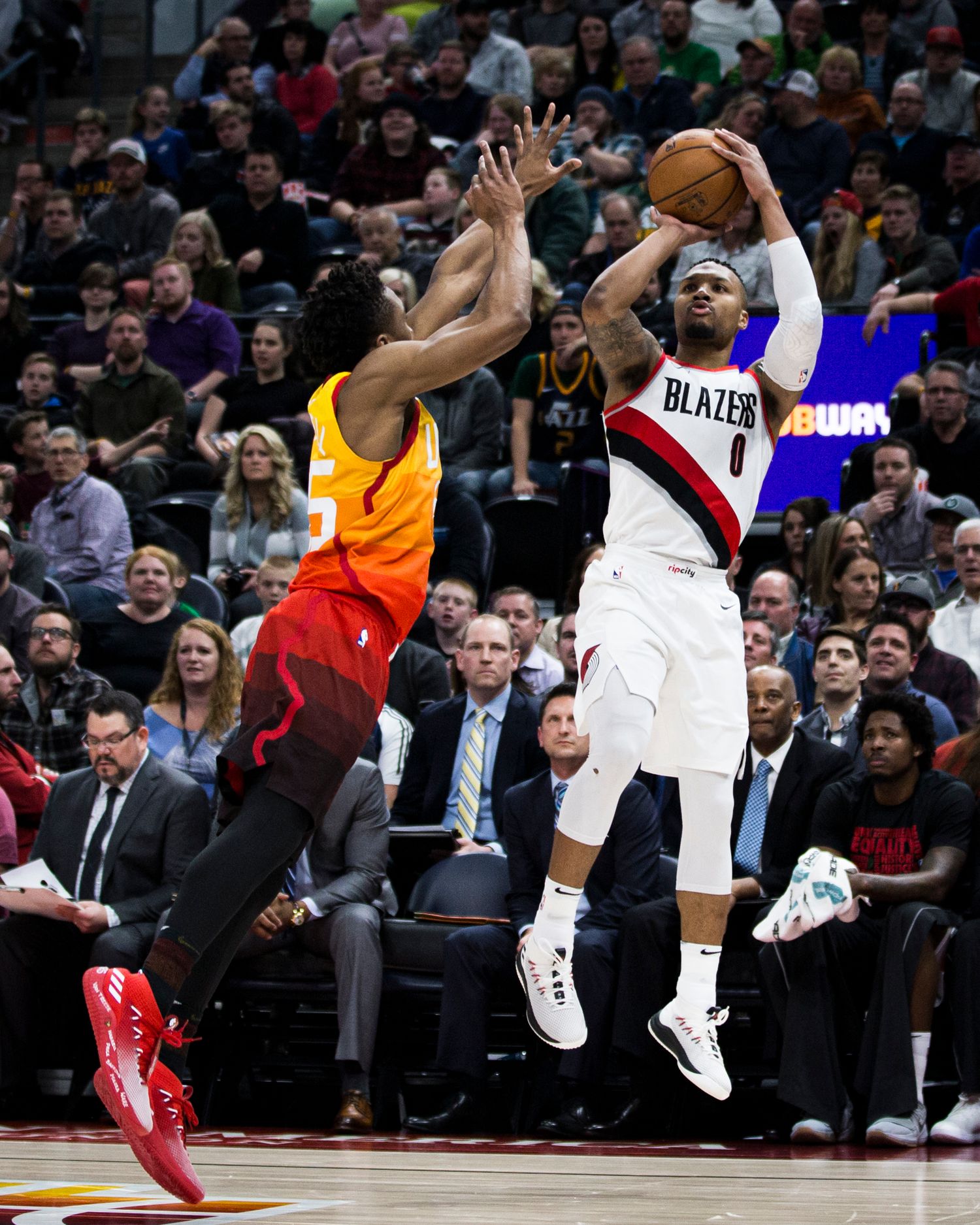 Professional basketball player attempts jump shot during NBA game.