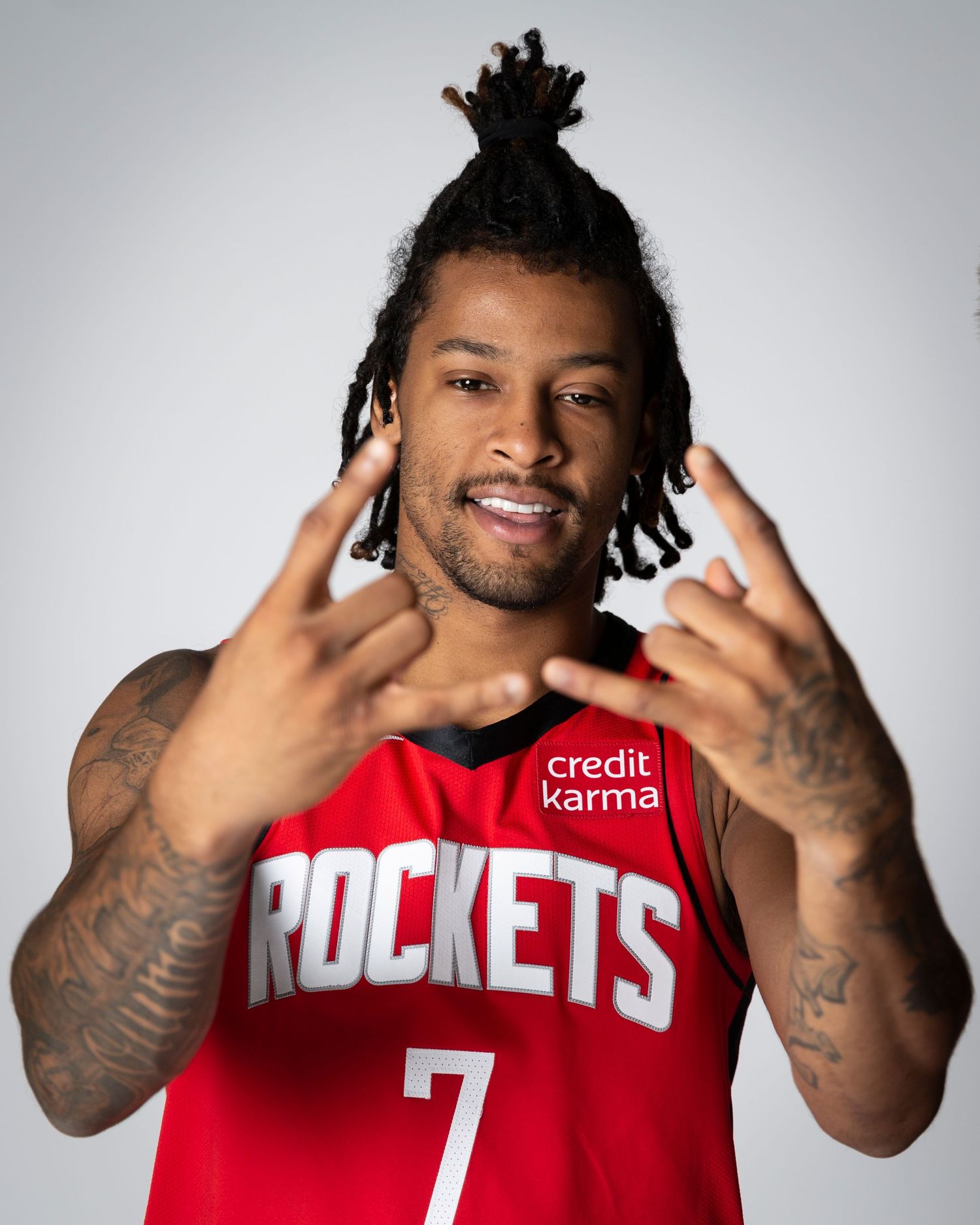 Professional basketball player in Houston Rockets jersey #7 poses during media day photoshoot.