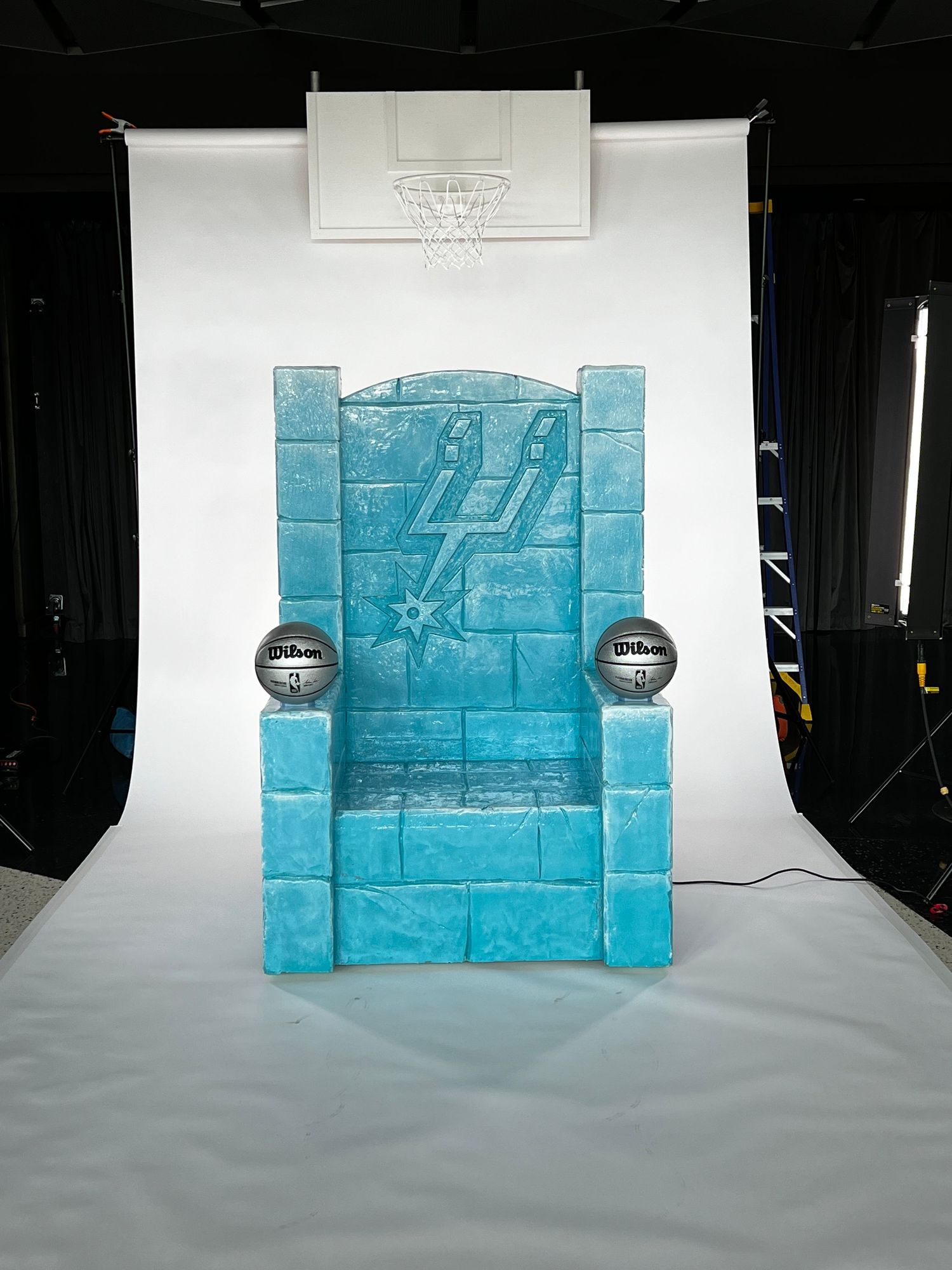 A sequence showing blue ice blocks arranged in a wall-like structure against a white studio background.