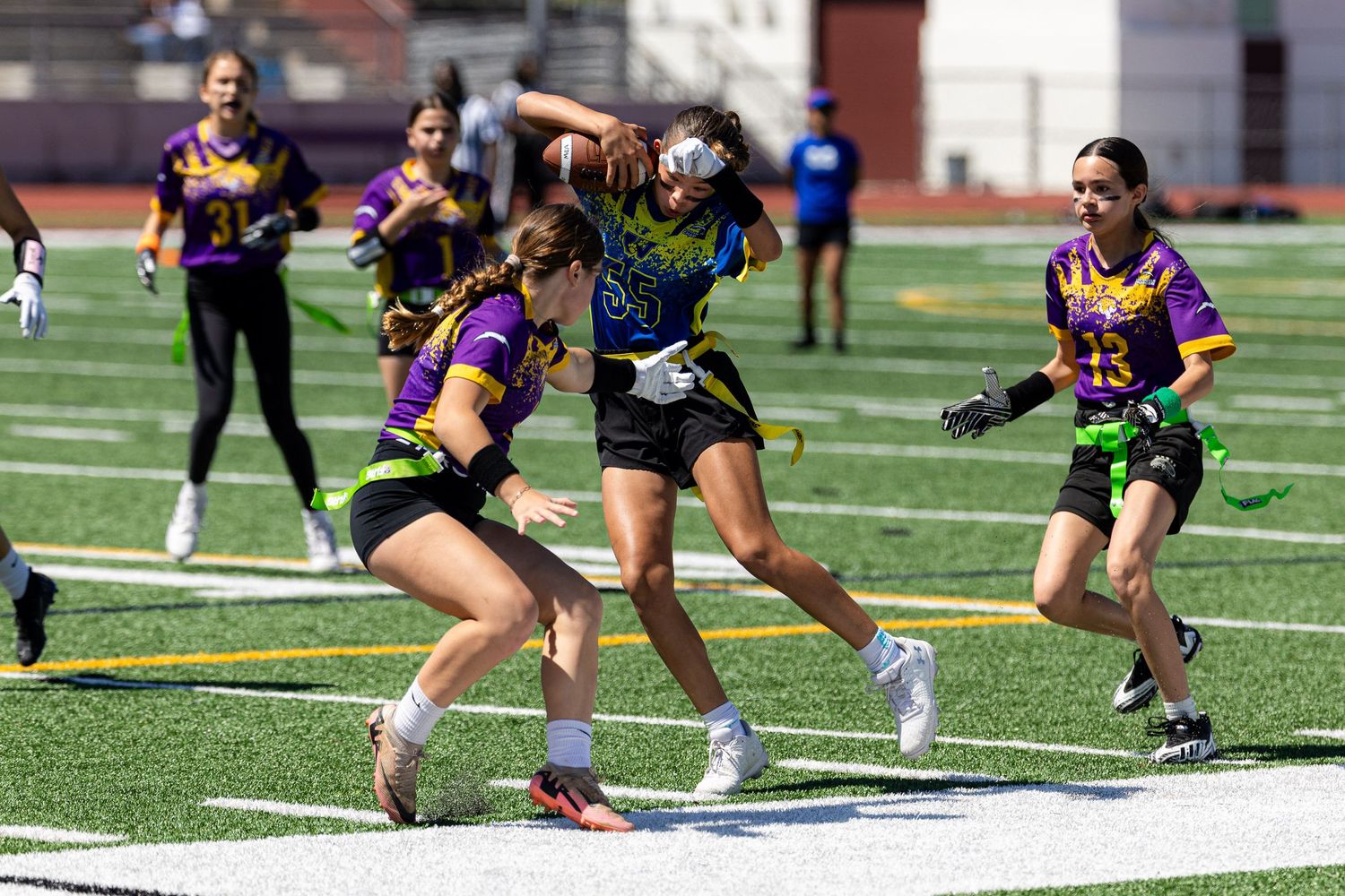 Girls flag football athlete dodging an opponent.
