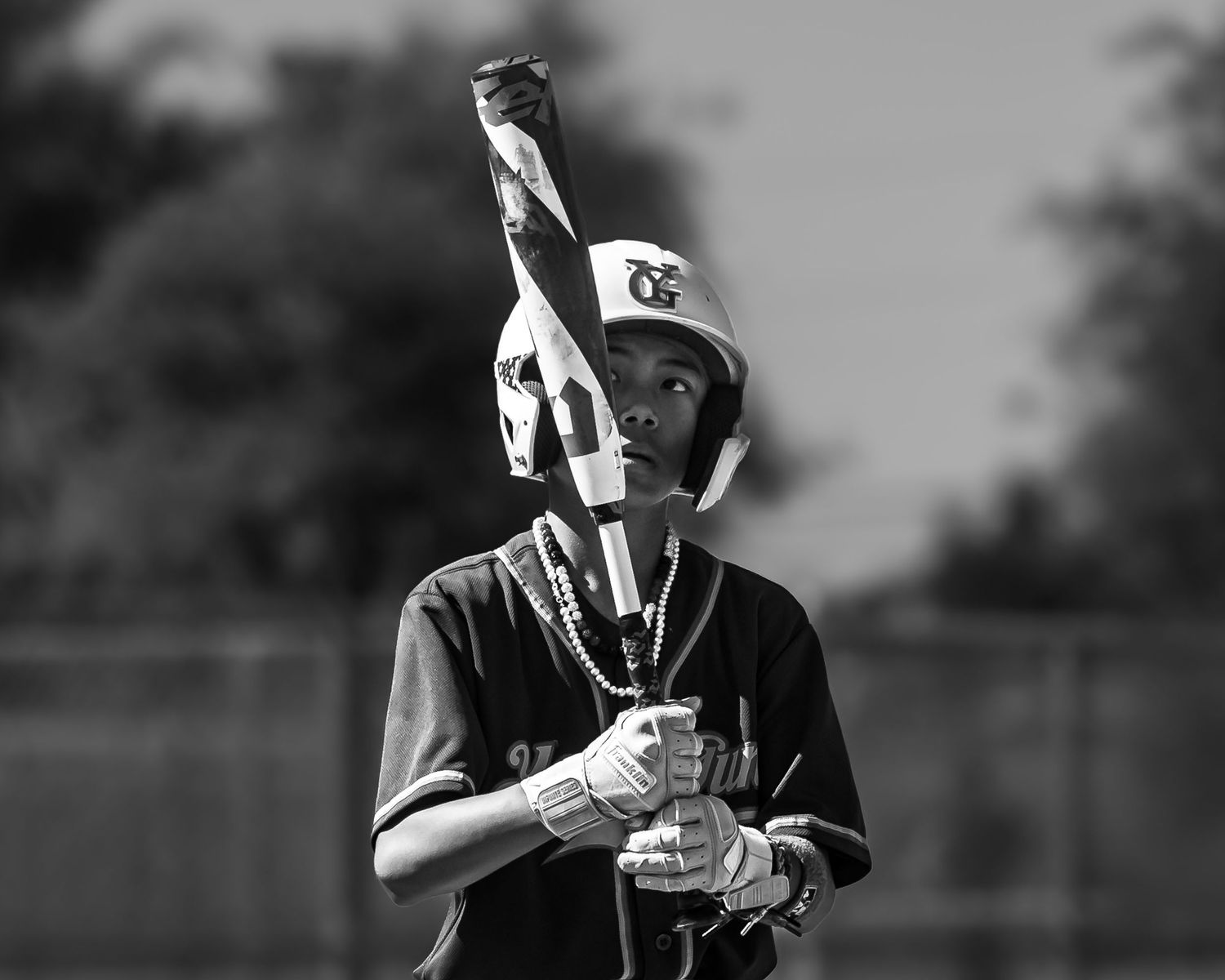 Baseball players in black uniforms warming up before a game.