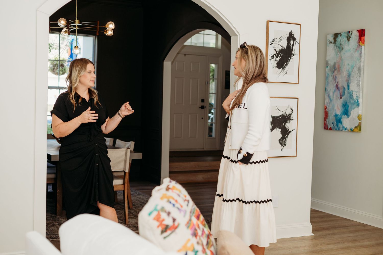 Celebration scene in modern home interior with people gathered around candles.