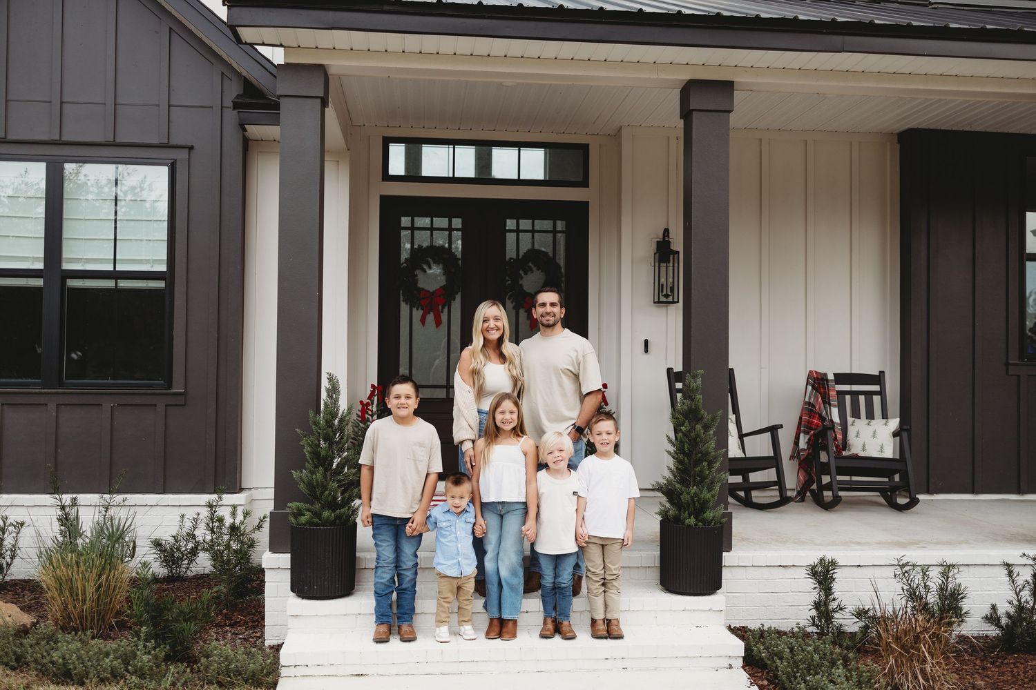 A collage of five photos showing a modern farmhouse exterior with white siding and black trim details.