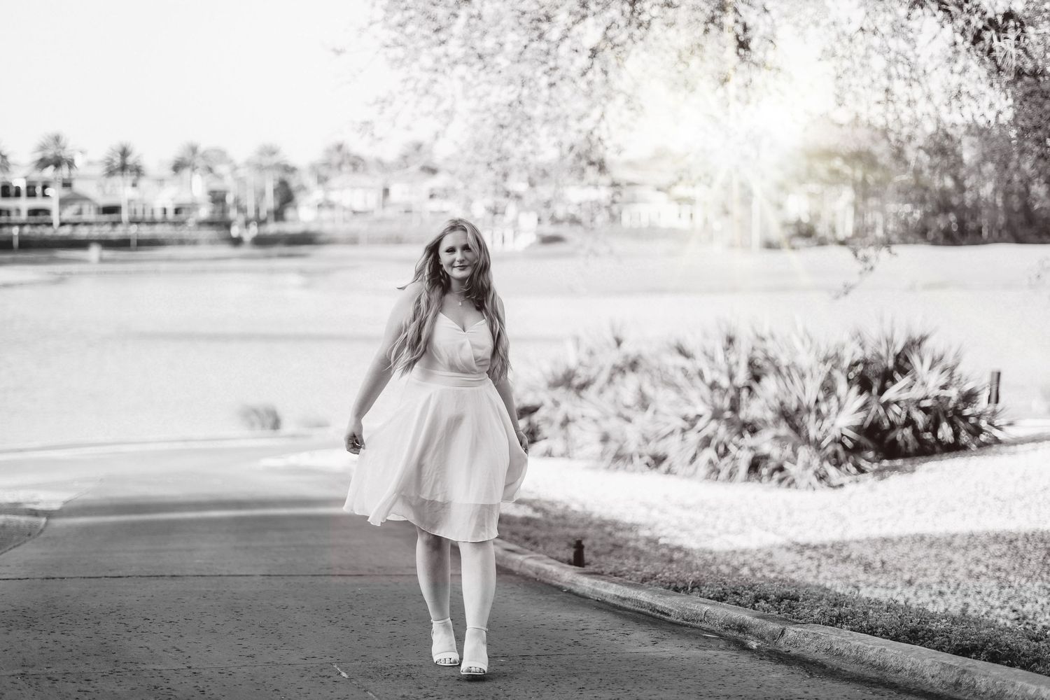 Black and white series of outdoor graduation portraits on a sunny day.