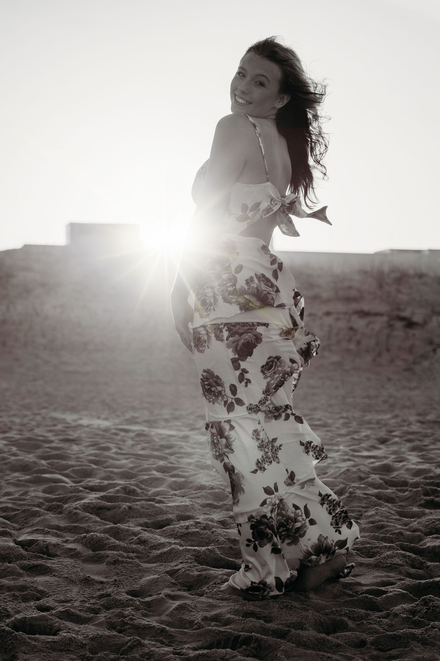 Artistic black and white beach photography sequence with flowing white dress in sunlight.