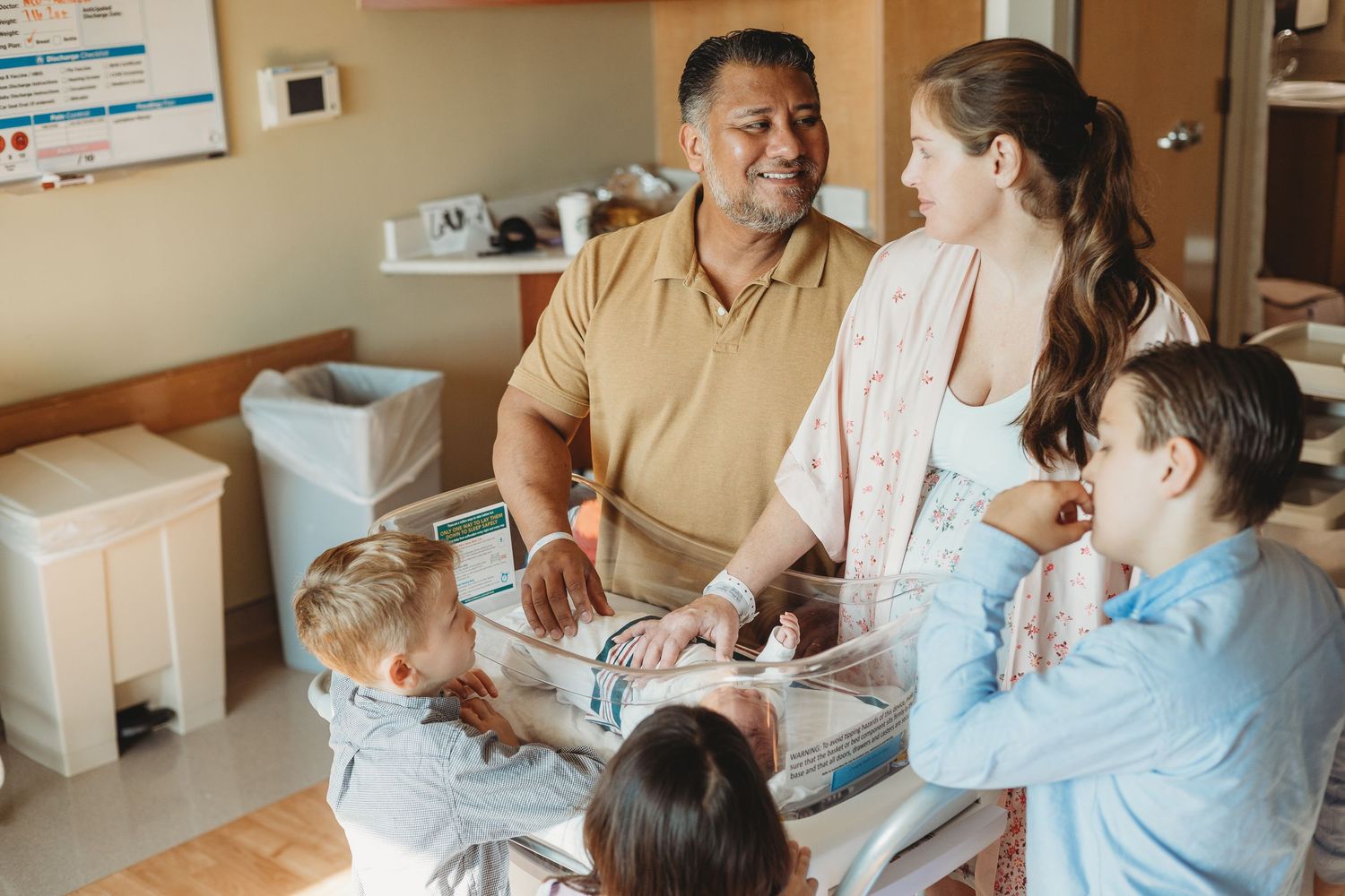 A heartwarming sequence of tender moments in a hospital room with a newborn baby.