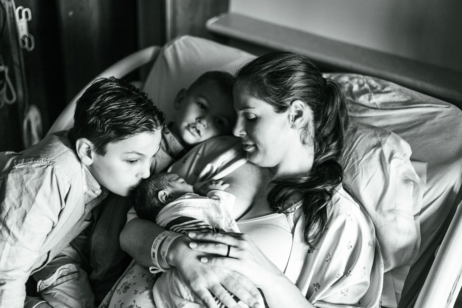 A series of black and white photographs capturing emotional moments with a newborn.