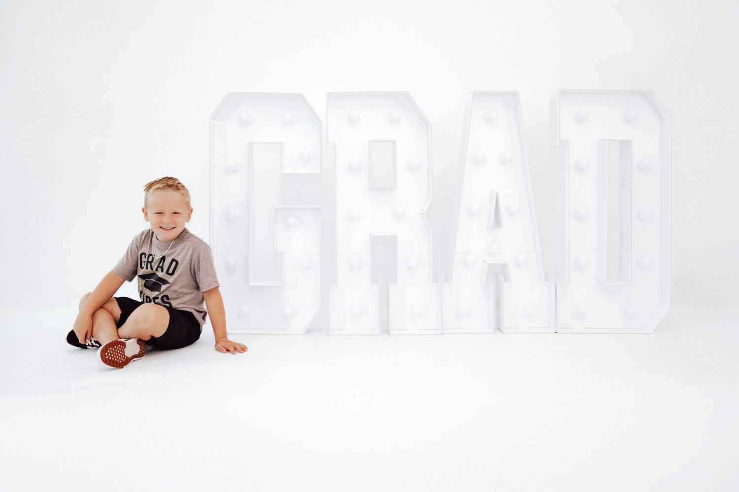 Baby crawling and playing against white studio background.