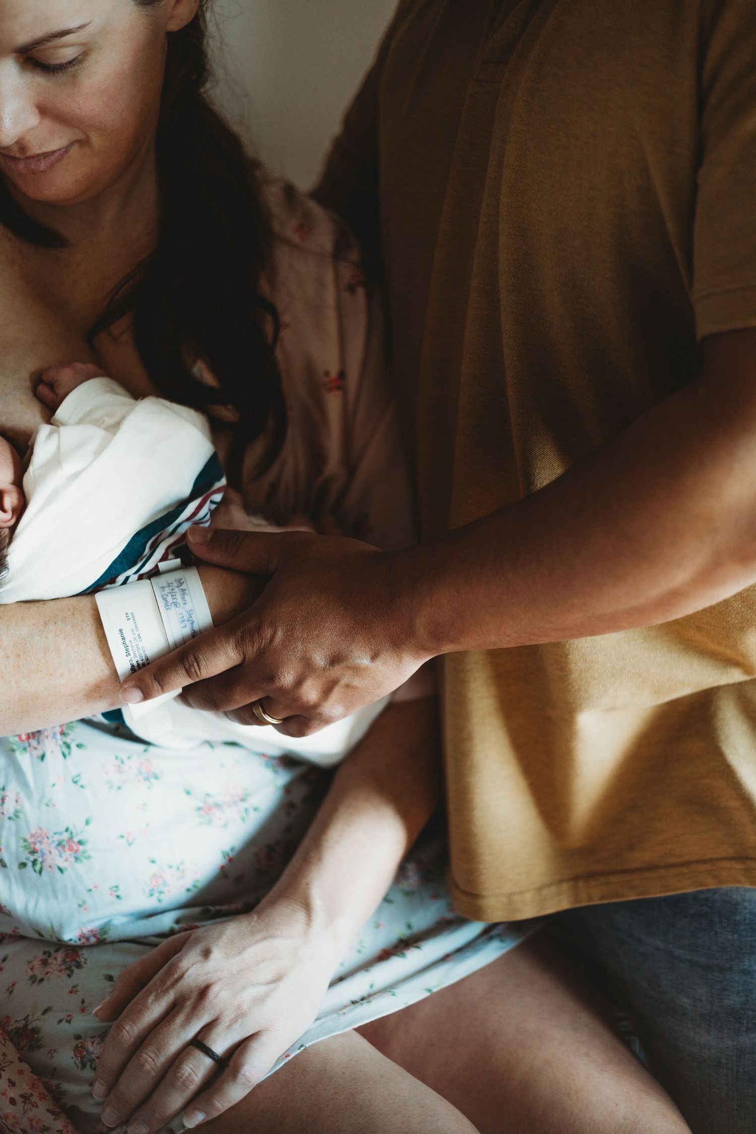 Close-up shots of gentle hands holding and comforting a newborn.