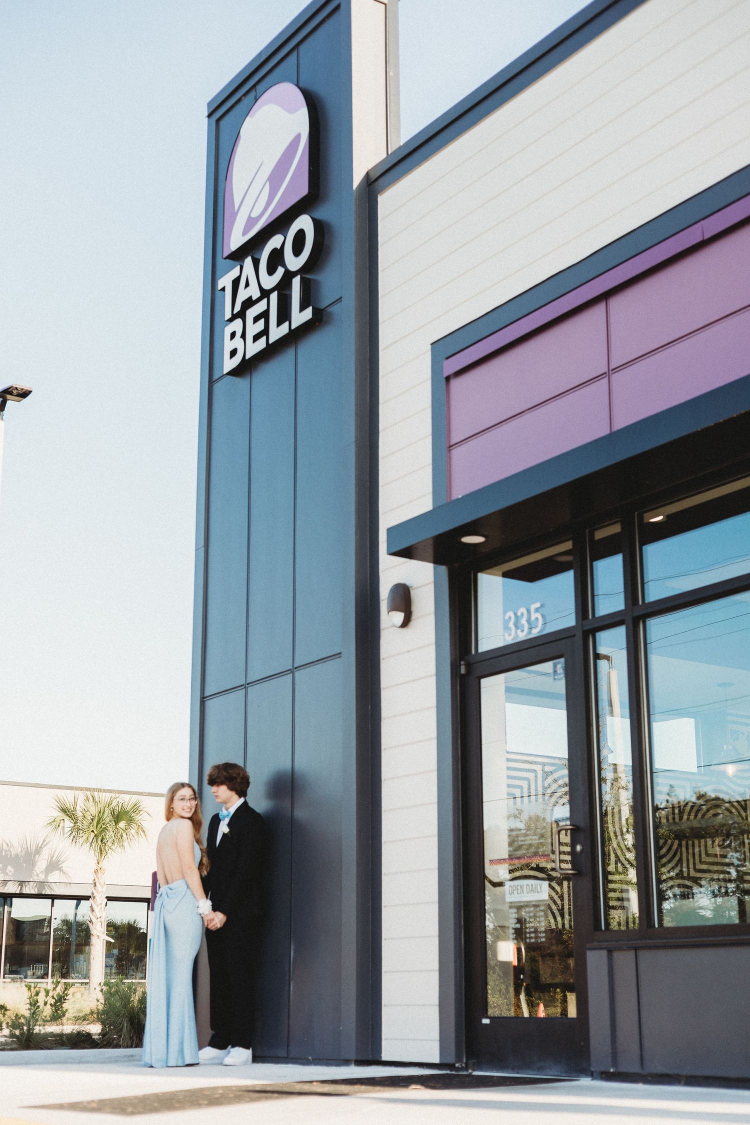 Modern Taco Bell storefront exterior with black and white signage.