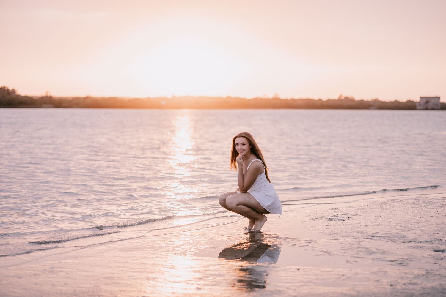 Romantic sunset photoshoot at the beach with golden hour lighting.