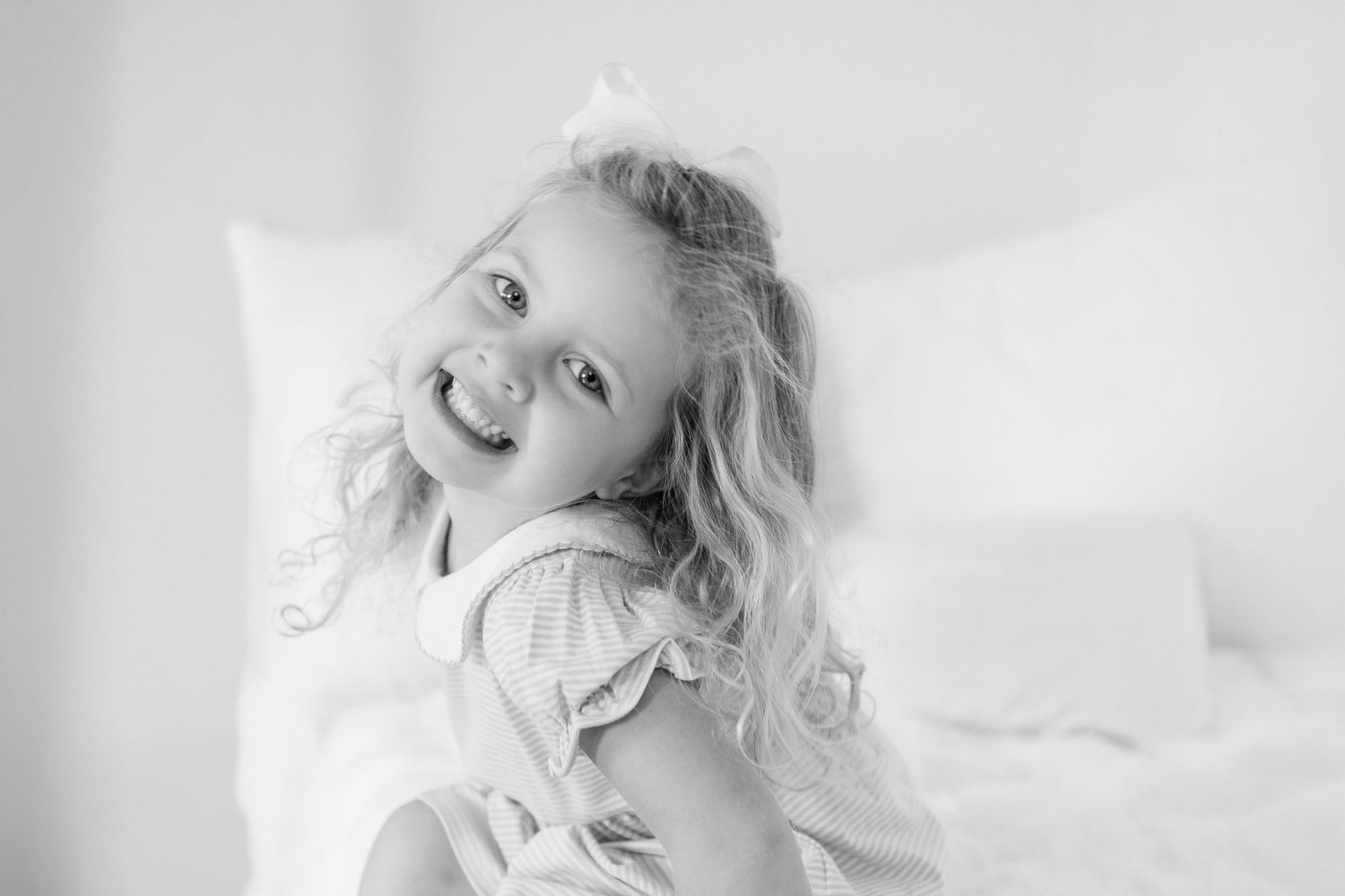 A series of black and white portrait photos showing a person posing with various expressions and angles.