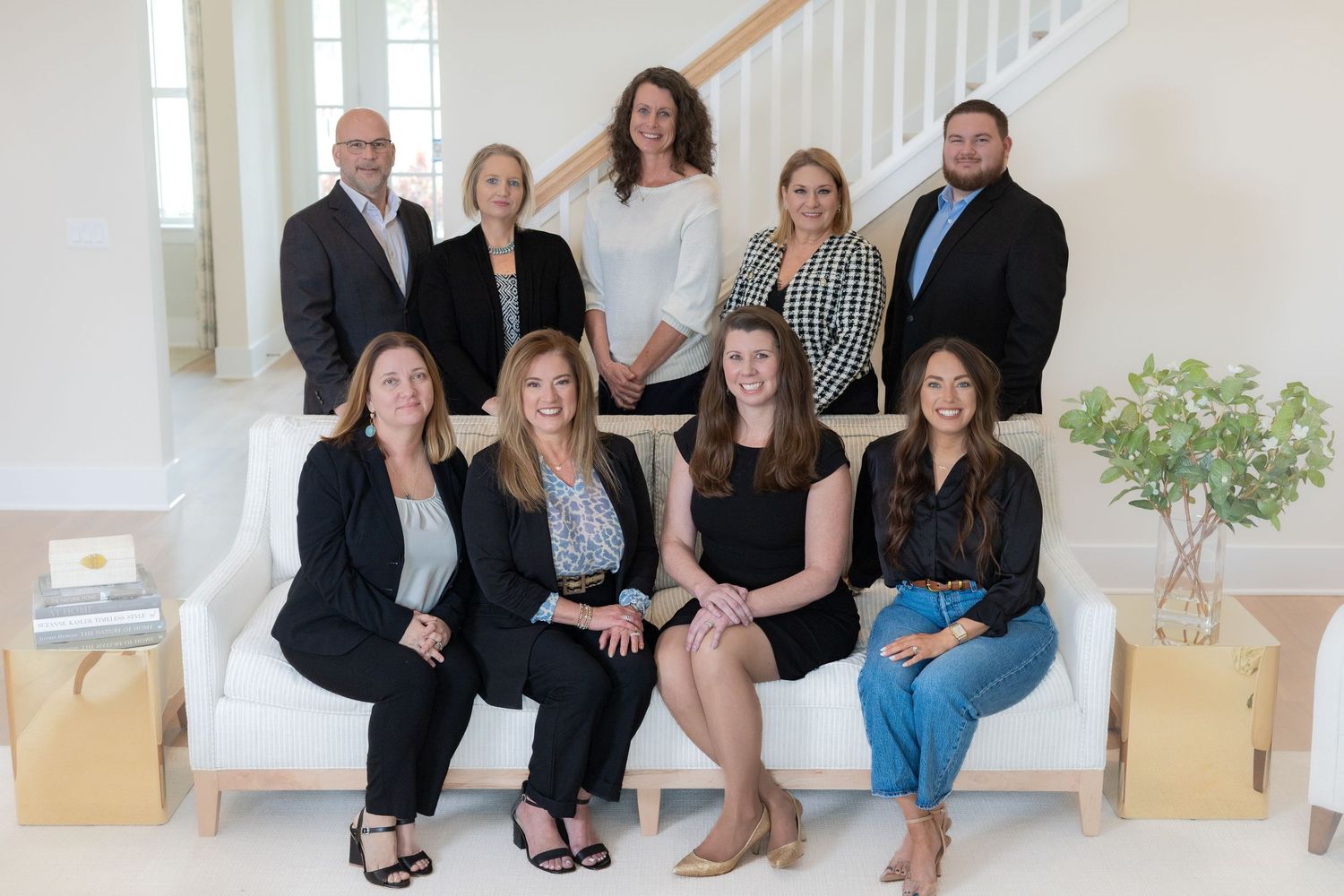 Group photo session on white stairs with casual business attire.