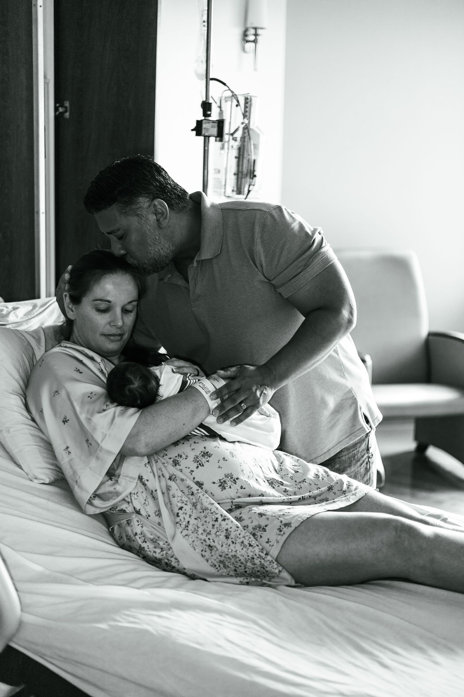 Black and white images showing intimate moments of care in a hospital setting.