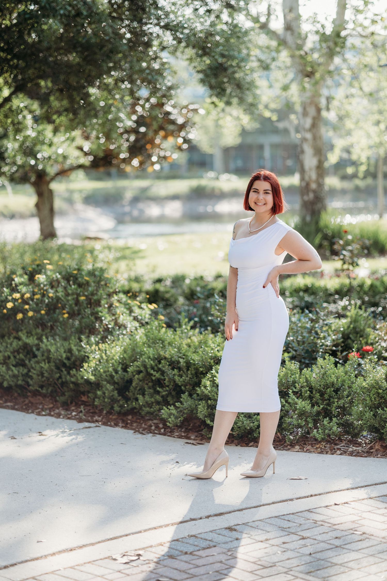 A series of playful dance poses in a white dress against a sunlit garden background with trees and shrubs.