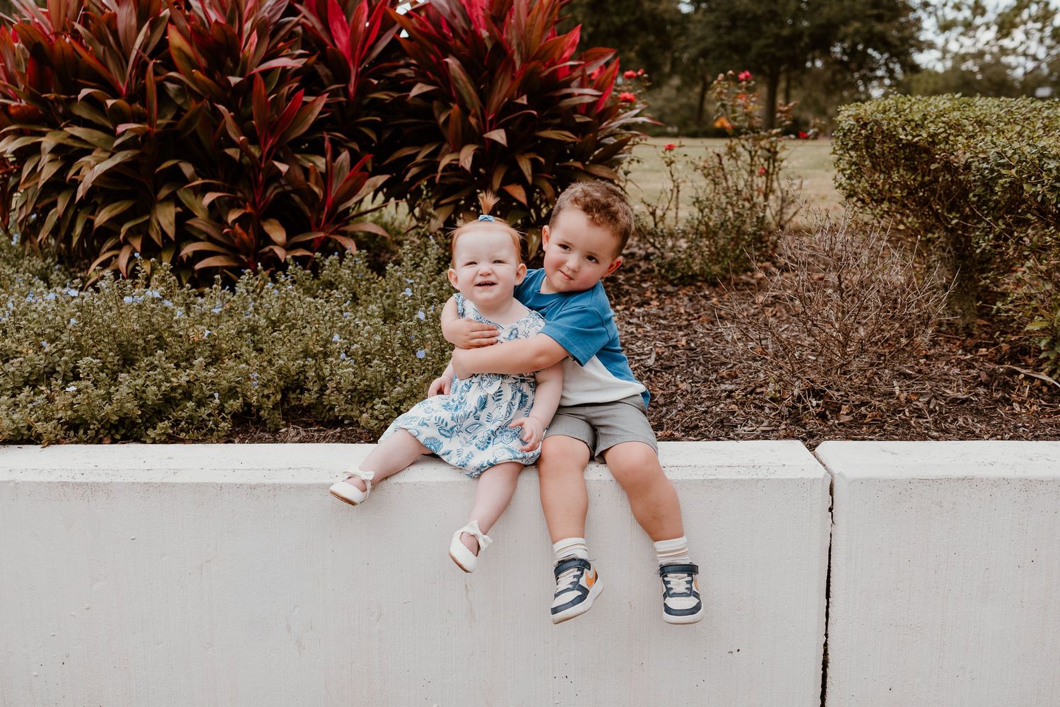 Children sitting together on concrete steps in a garden setting at different angles and moments.