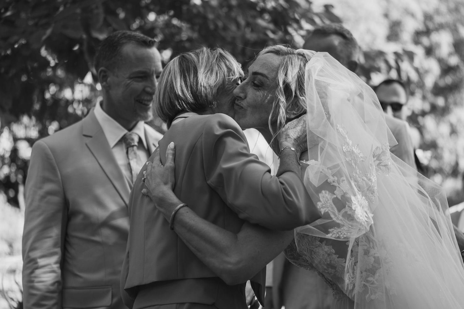 A black and white photo montage of wedding moments showing couples embracing and celebrating during their special day.