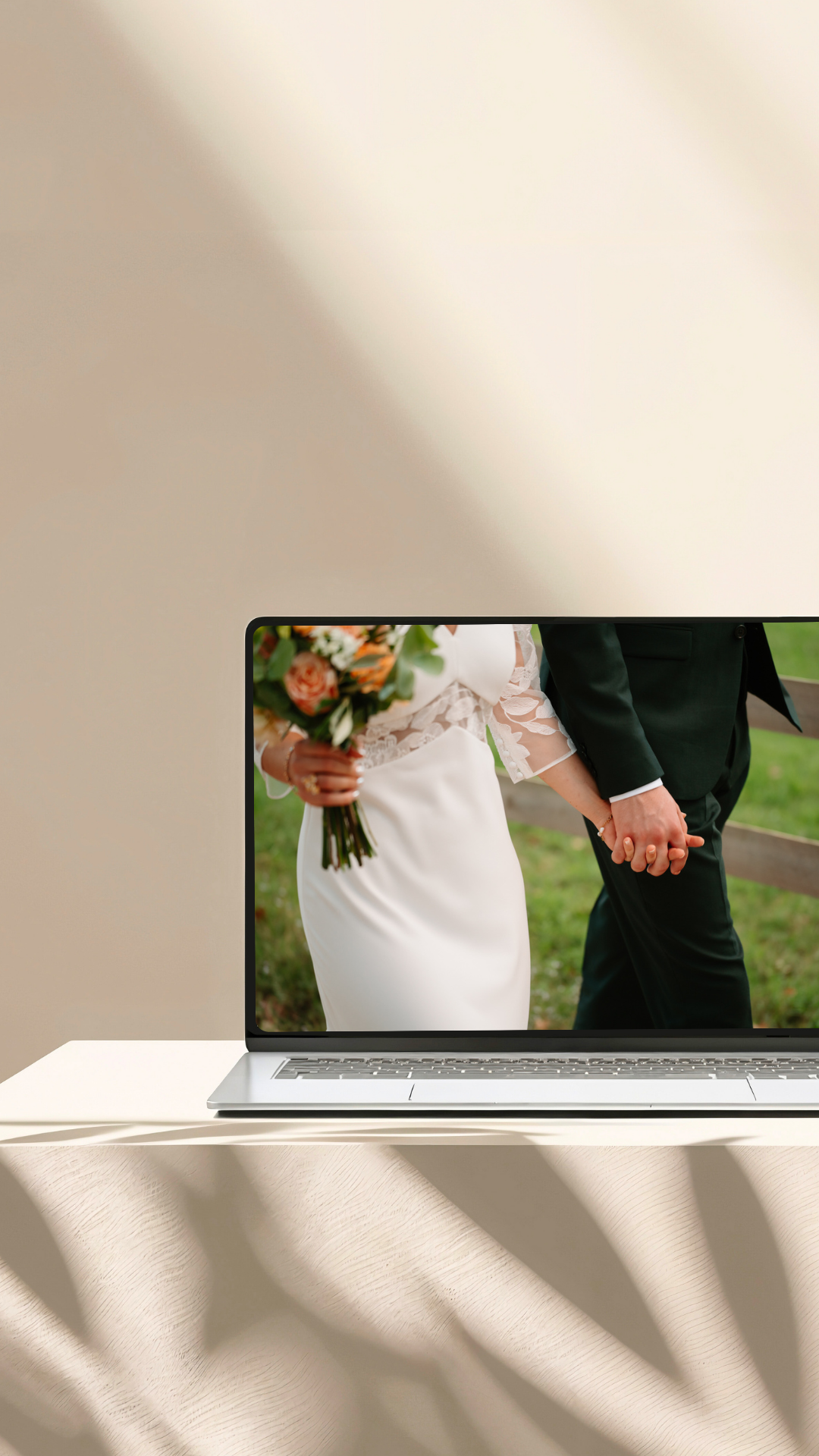 Close-up shot of a bride and groom holding hands during an outdoor wedding ceremony.